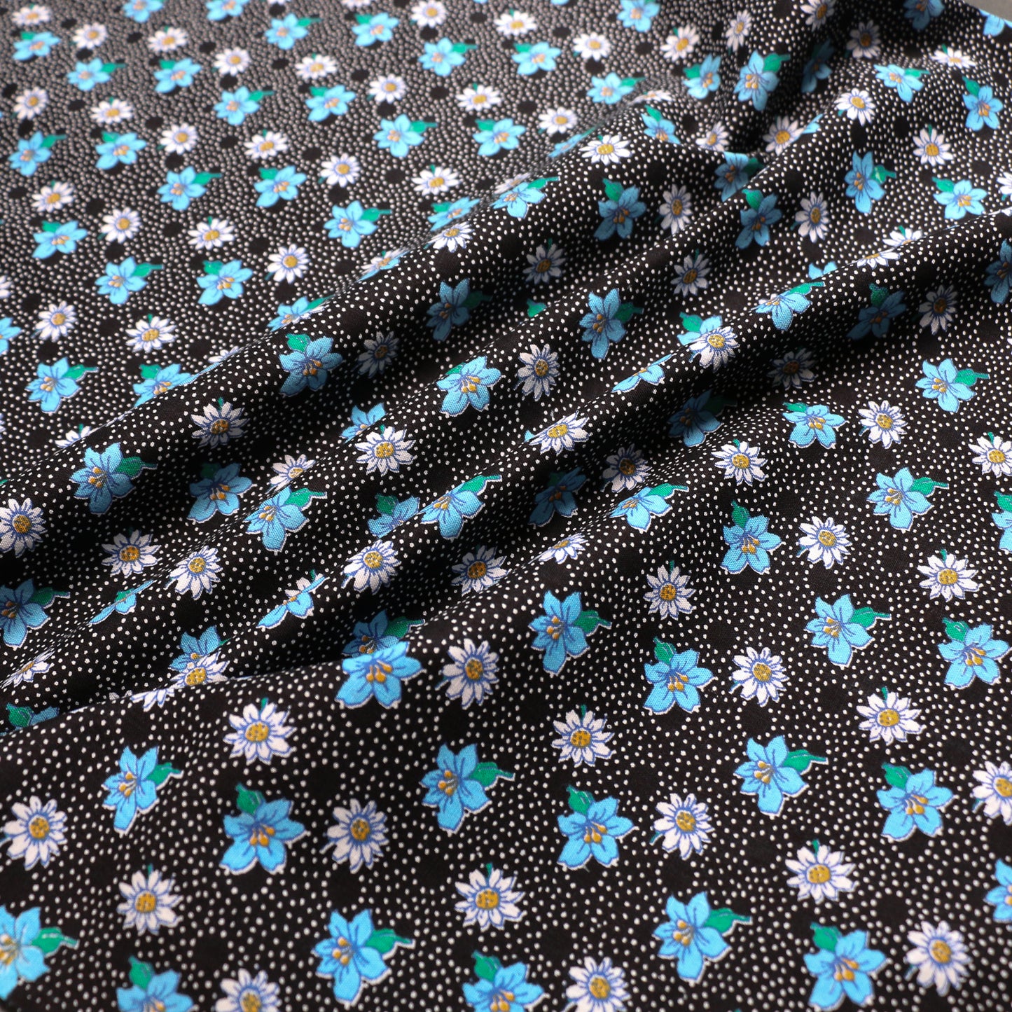 vintage cotton dressmaking fabric in black with blue white floral print