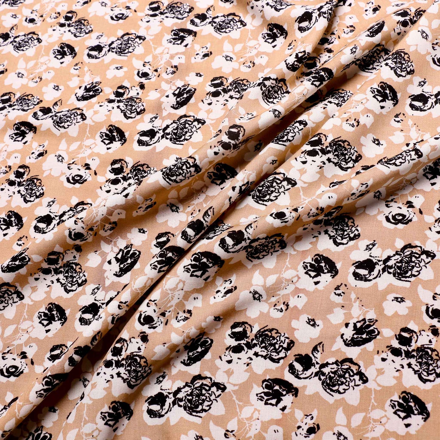 beige viscose challis dressmaking fabric with black flowers