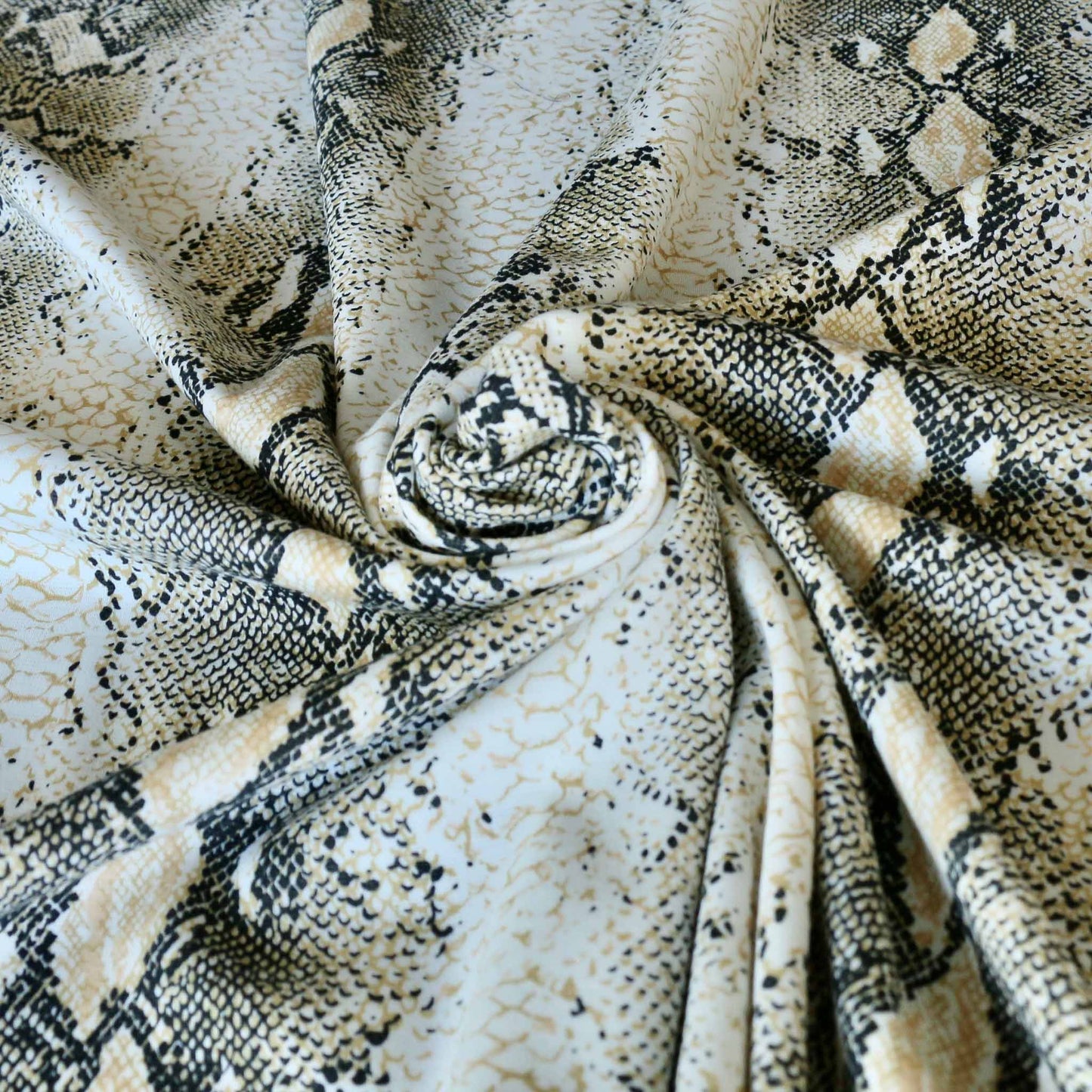 snake skin print in black and gold on ponte roma dressmaking fabric
