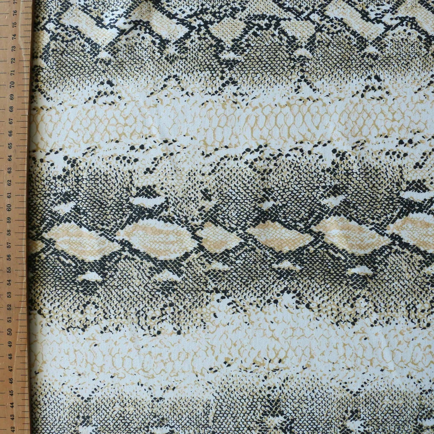 metre snake skin printed ponte roma dressmaking fabric in gold and black