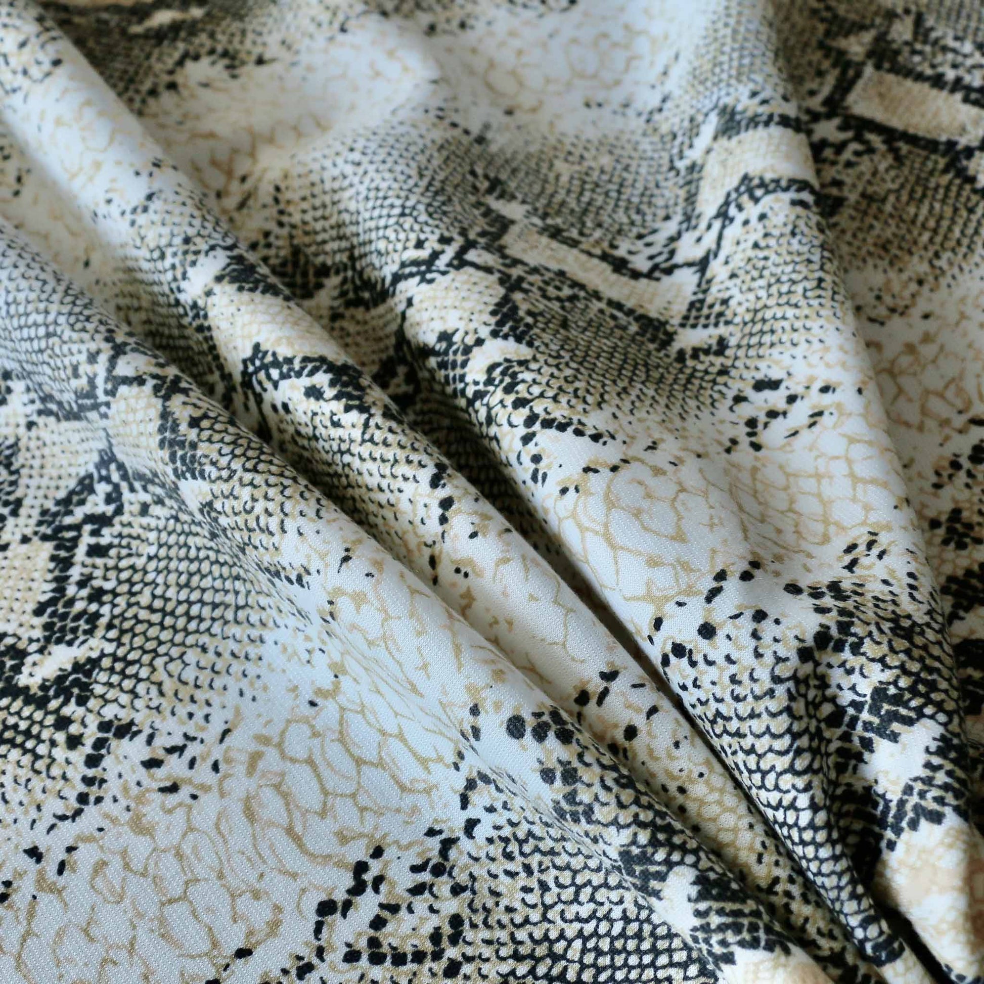 snake skin print in gold and black dressmaking ponte roma fabric