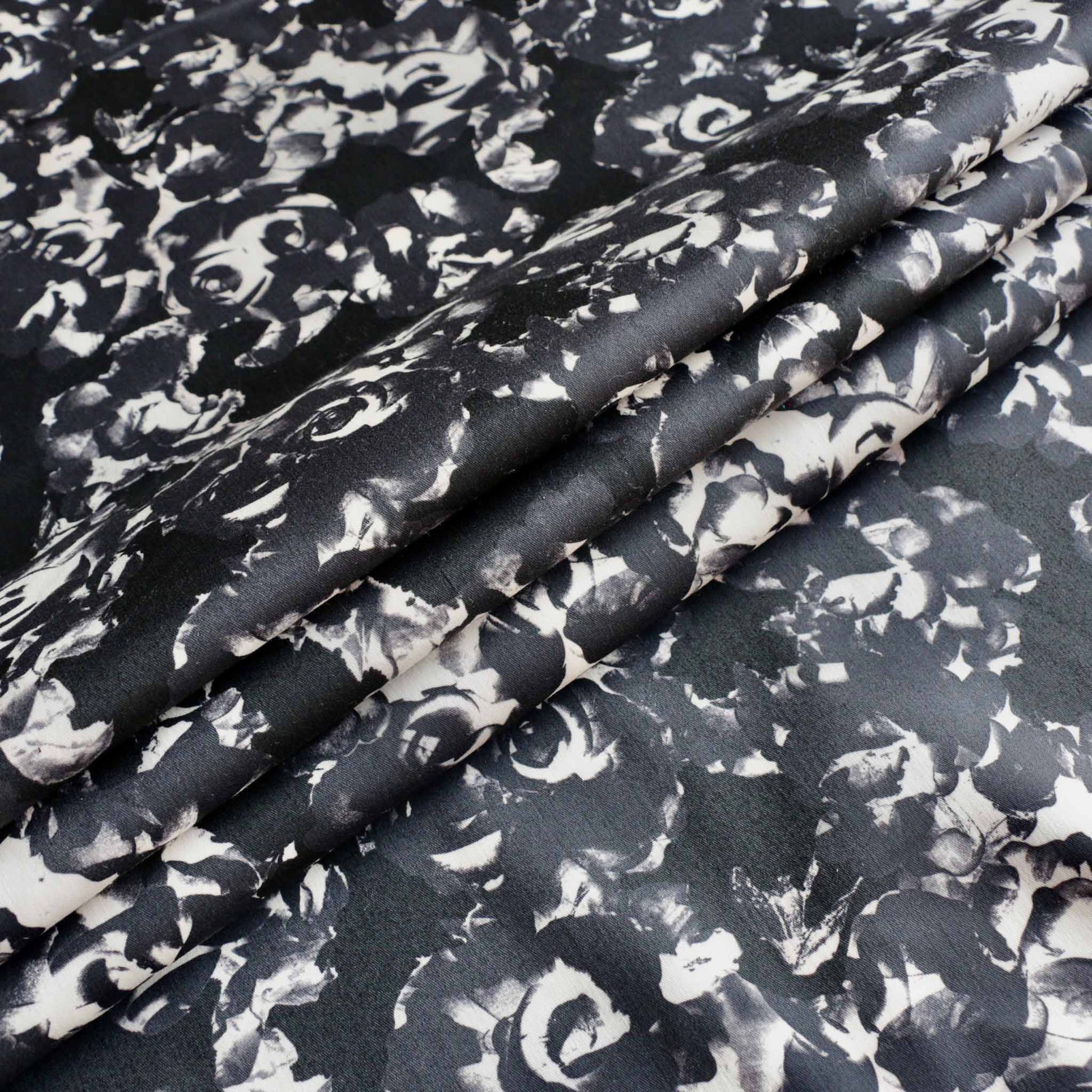folded stretchy dressmaking cotton sateen fabric in black and grey with floral print design