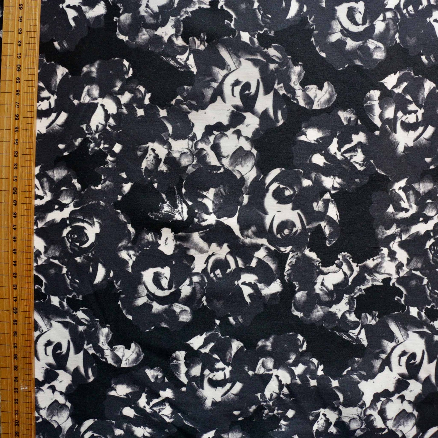metre stretchy cotton sateen dressmaking fabric with grey and black floral design
