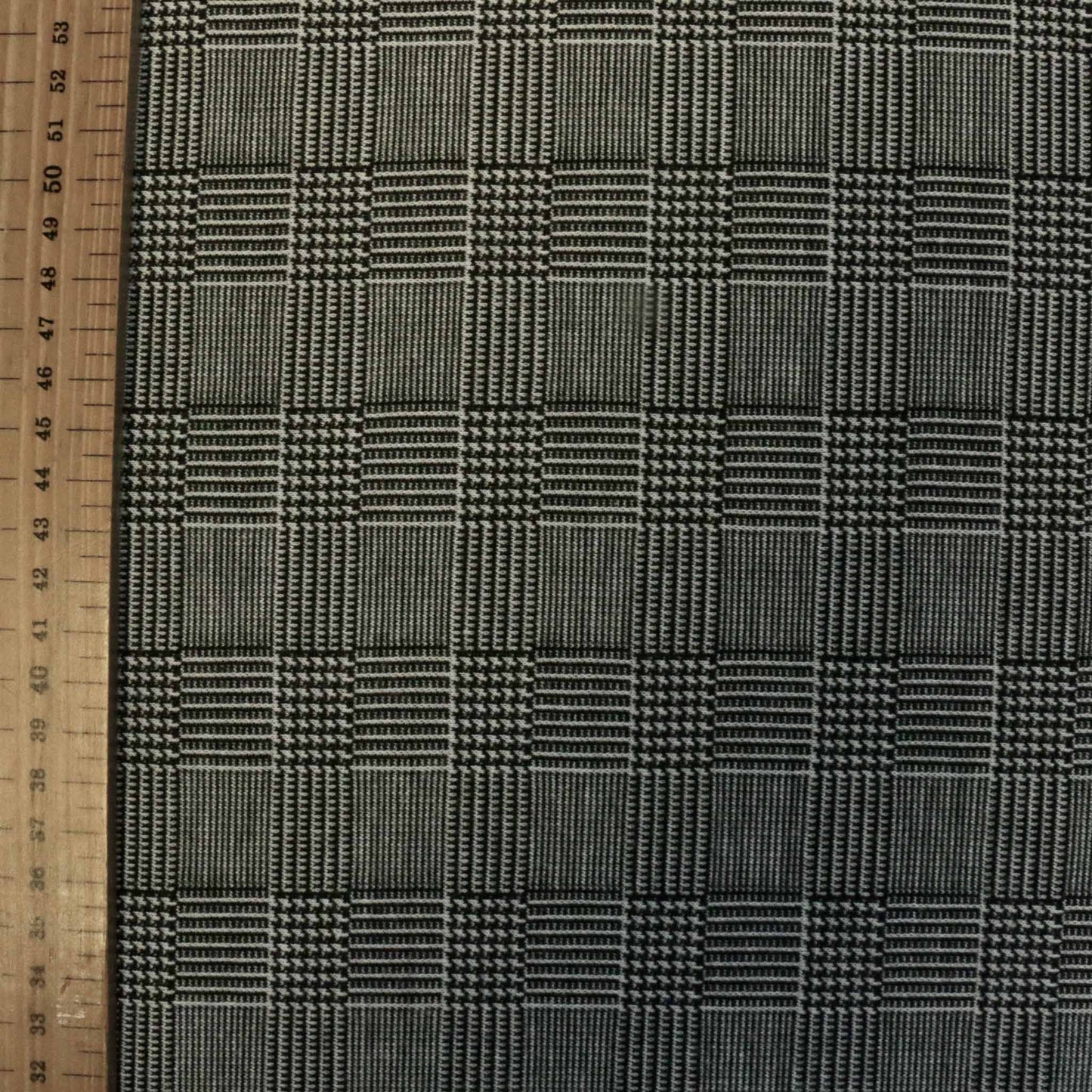 metre prince of wales tartan dressmaking jersey fabric in black and grey stretch check