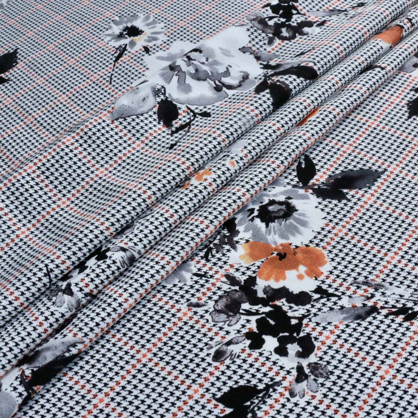 white and orange flowers printed on black houndstooth check viscose challis dressmaking fabric