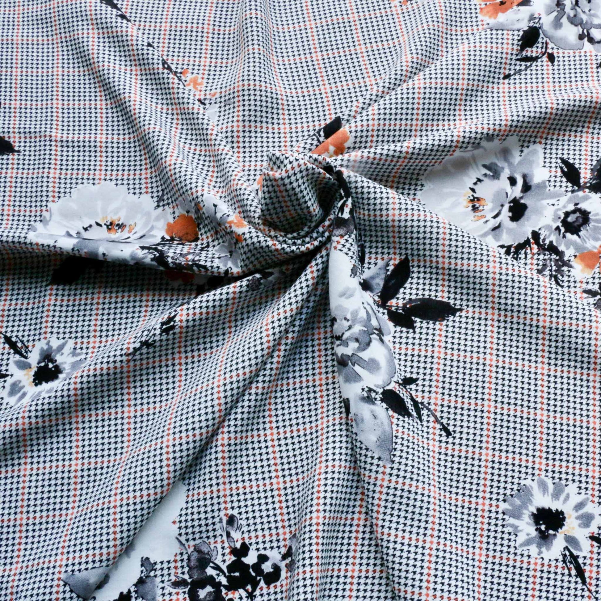 houndtooth check viscose challis dressmaking fabric in grey with black and orange floral design