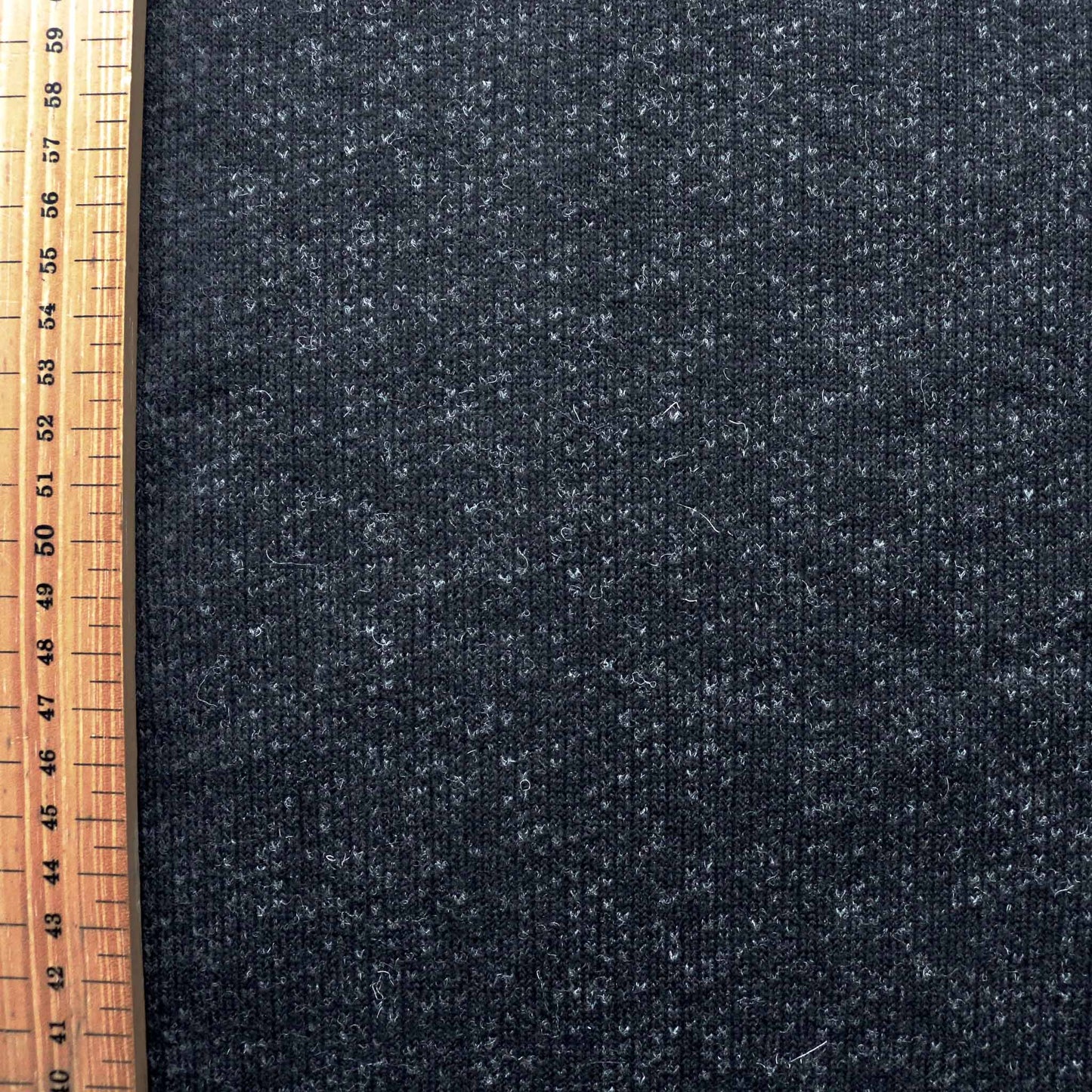 metre wool jersey dressmaking fabric in black and grey with felt back