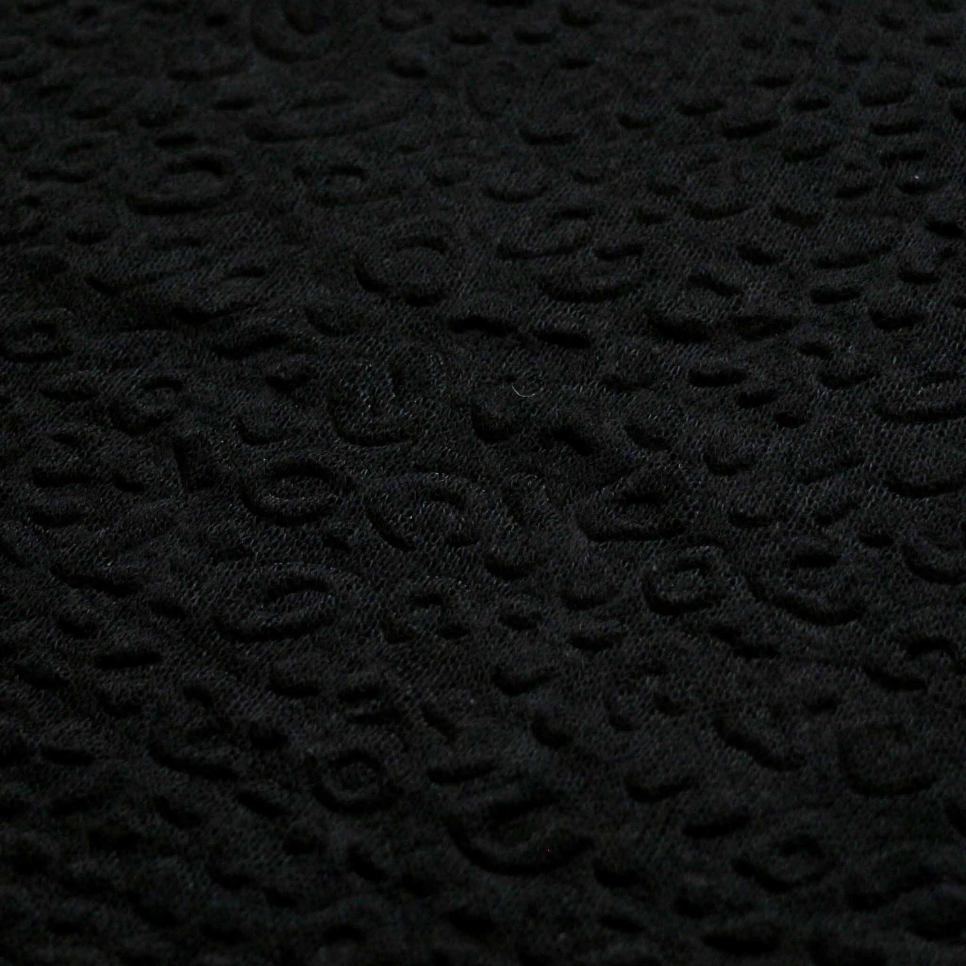jersey knit black dressmaking fabric with embossed decorative patterned texture