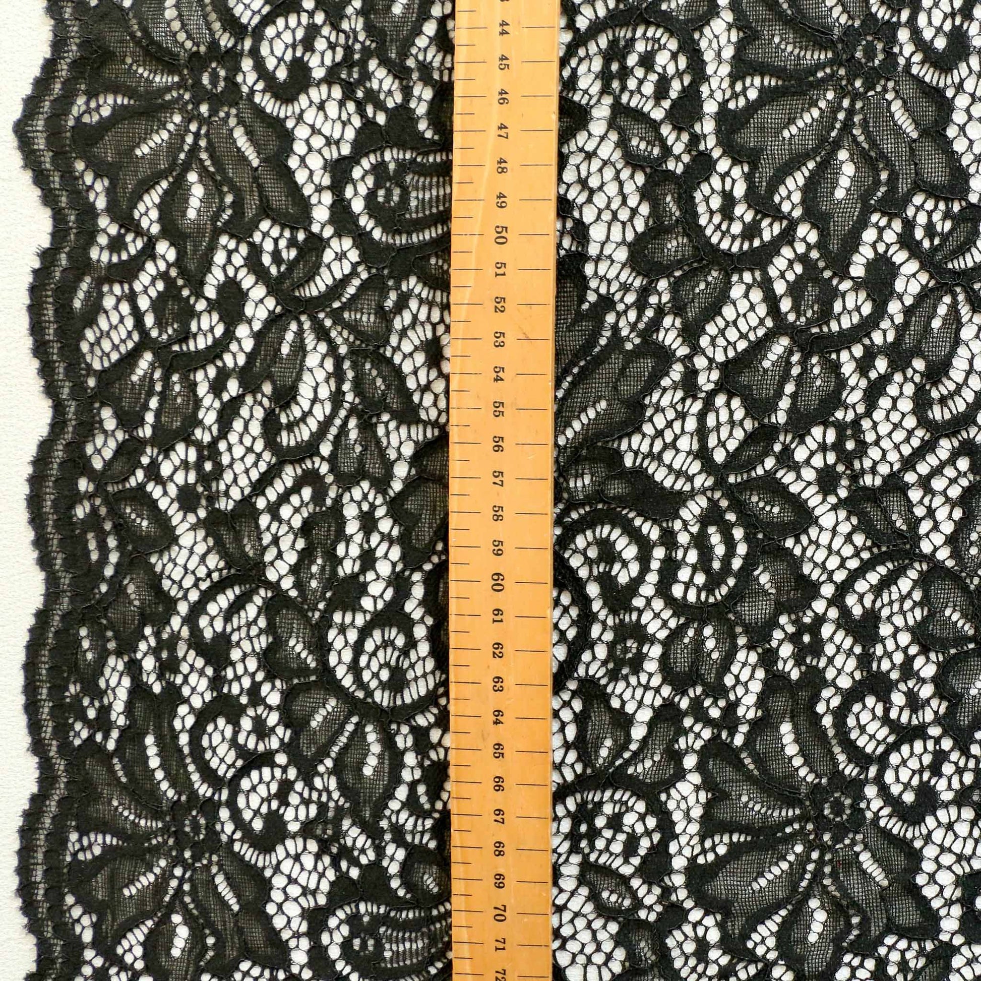 stretchy black lace dressmaking fabric with corded scalloped edge