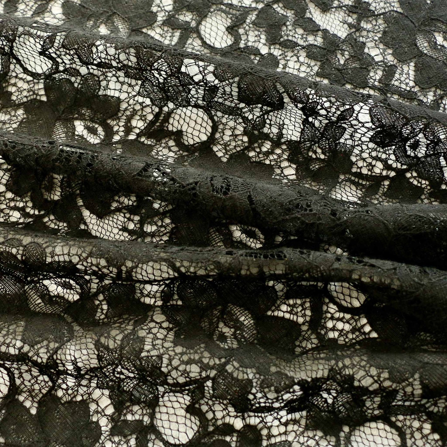 black lace dressmaking fabric with corded scalloped edge