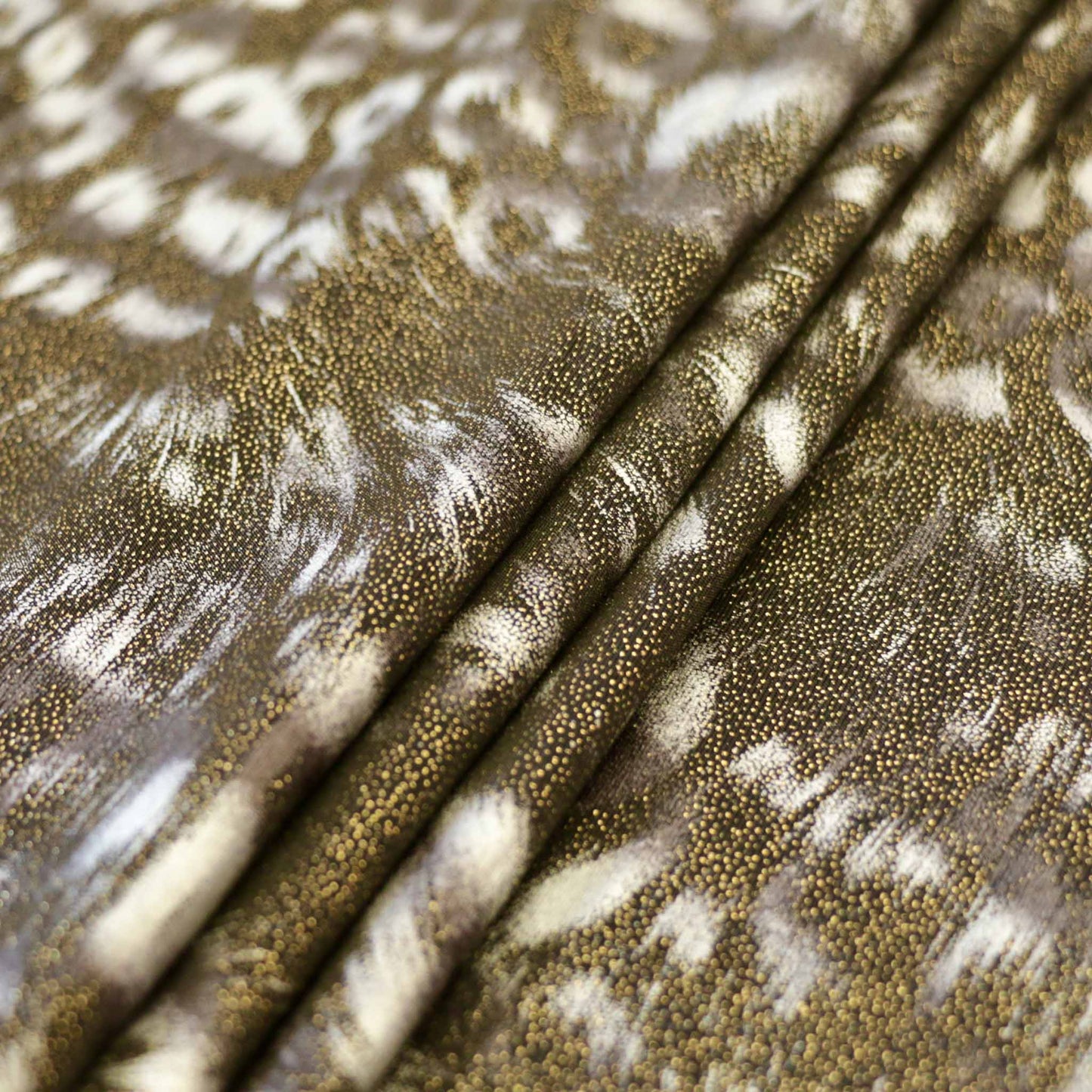 shimmer effect gold and black lycra dressmaking fabric with animal skin print