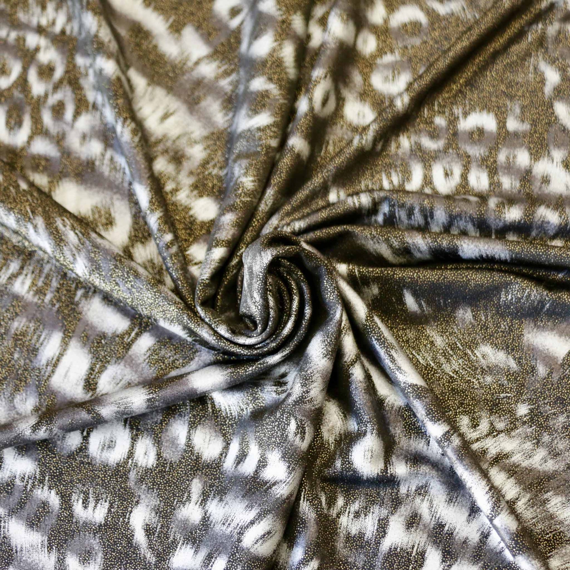 black and gold animal print shimmer lycra dressmaking fabric