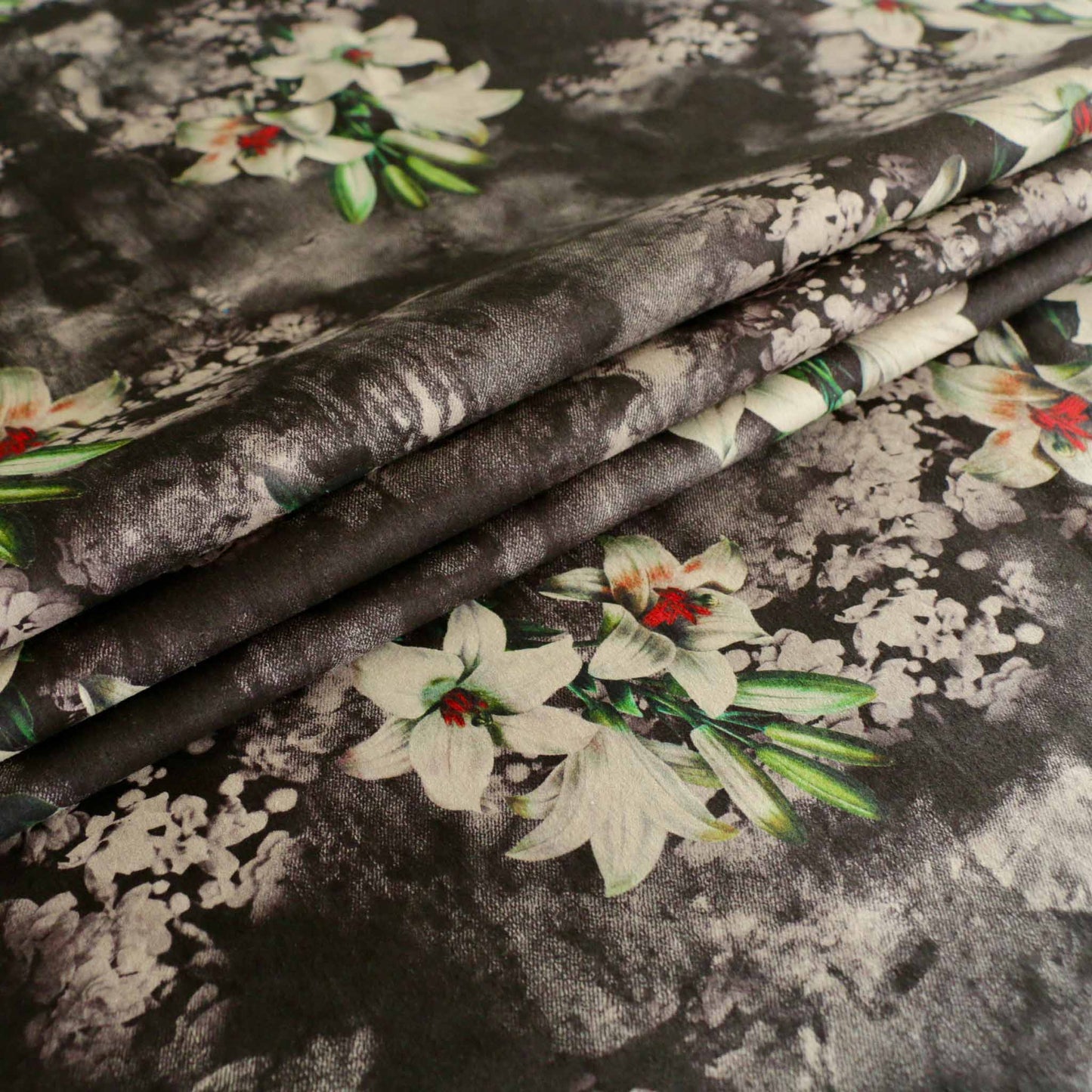 black suede moleskin dressmaking fabric with white lily flower design