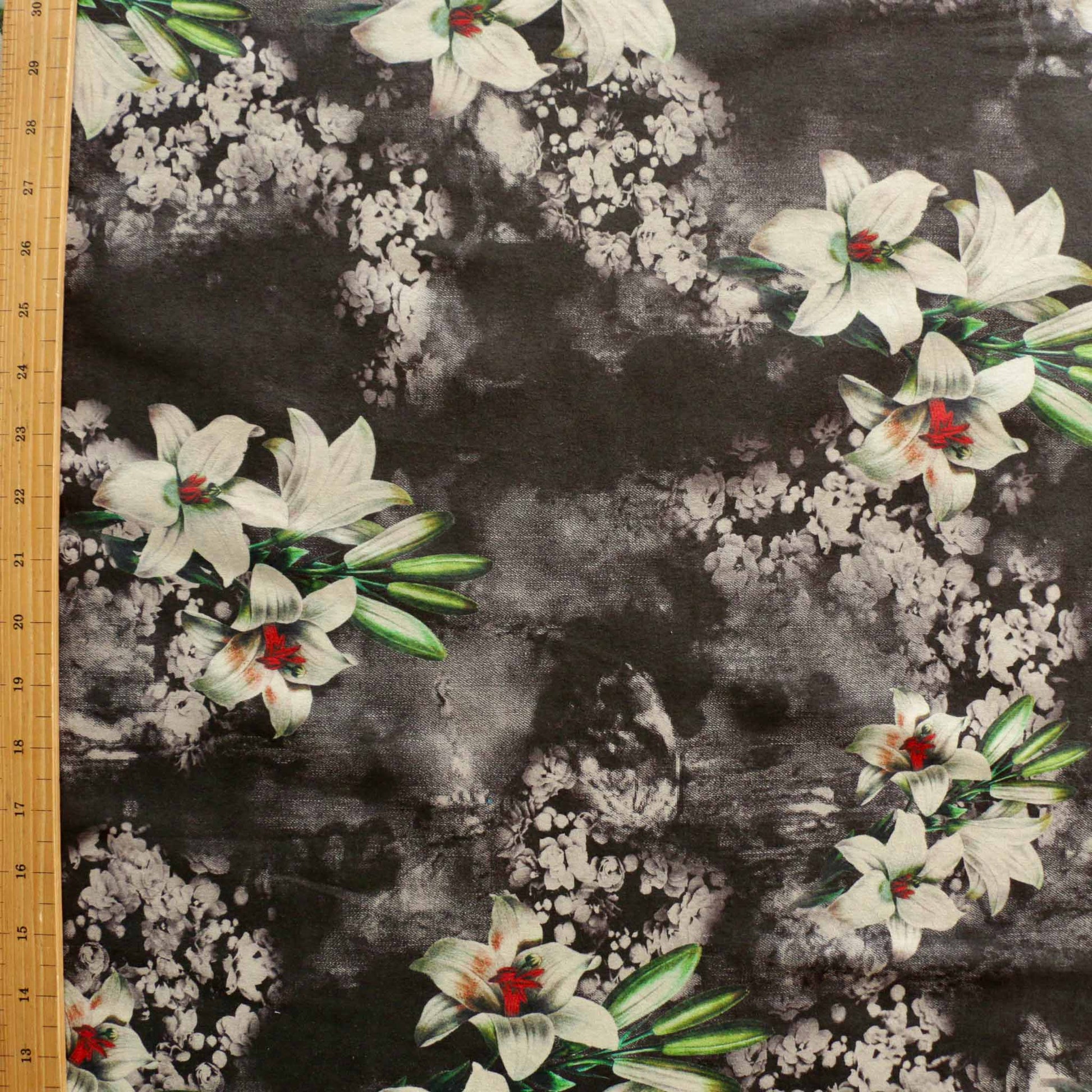 metre suede moleskin dressmaking fabric in black with white lily flower design