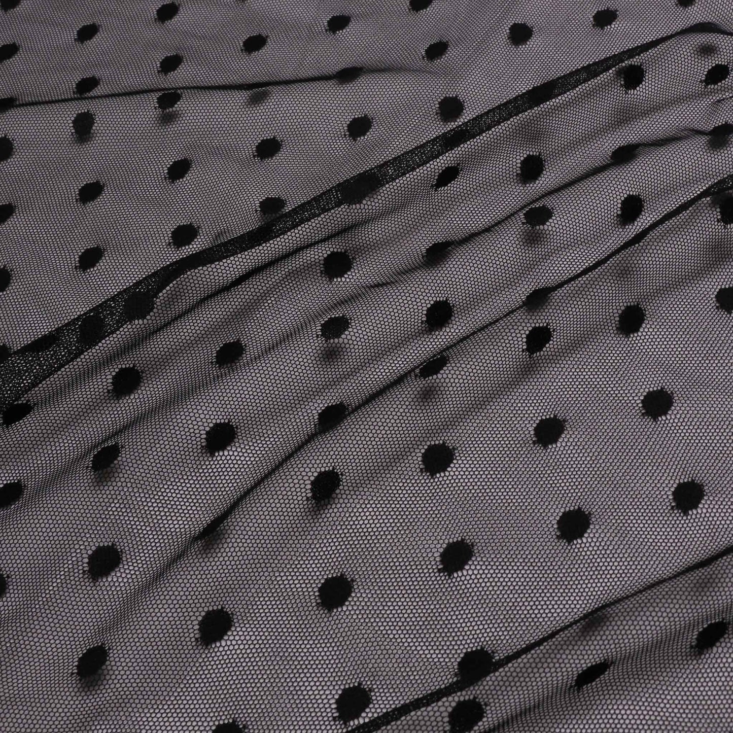 black netting mesh dressmaking fabric with polka dot design