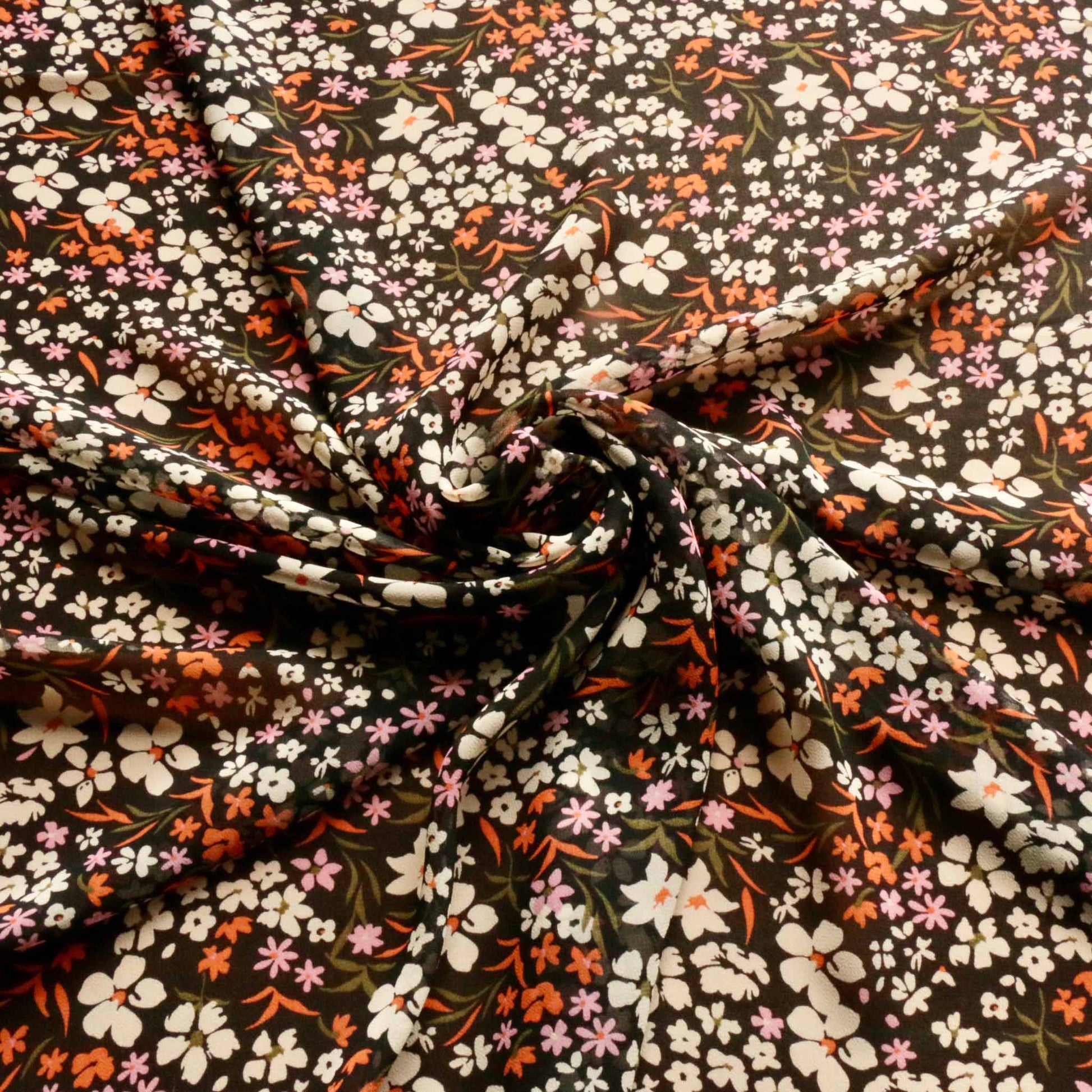 black viscose chiffon dressmaking fabric with flowery print in orange and white