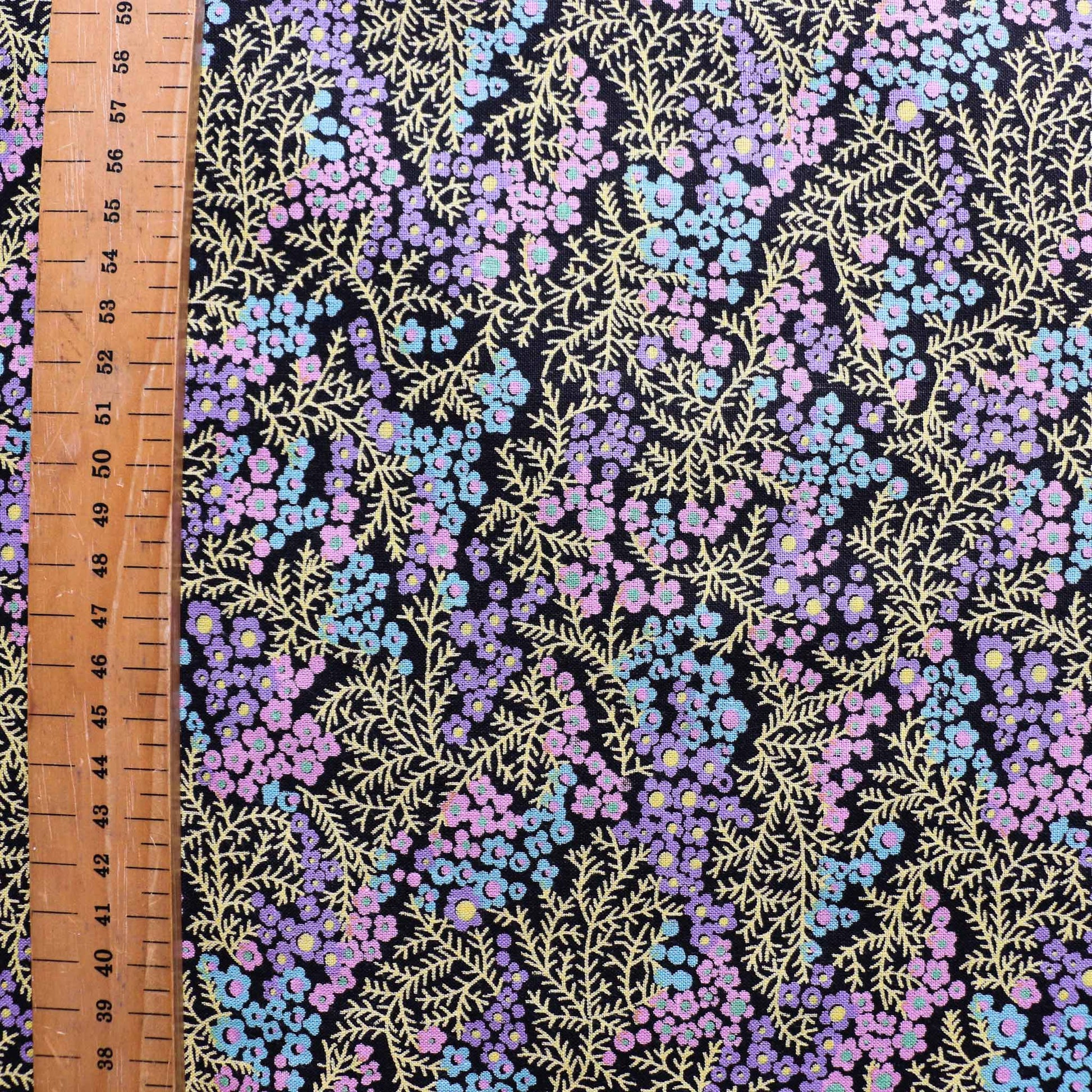 metre black sustainable vintage cotton dressmaking fabric with multicoloured ditsy flower design