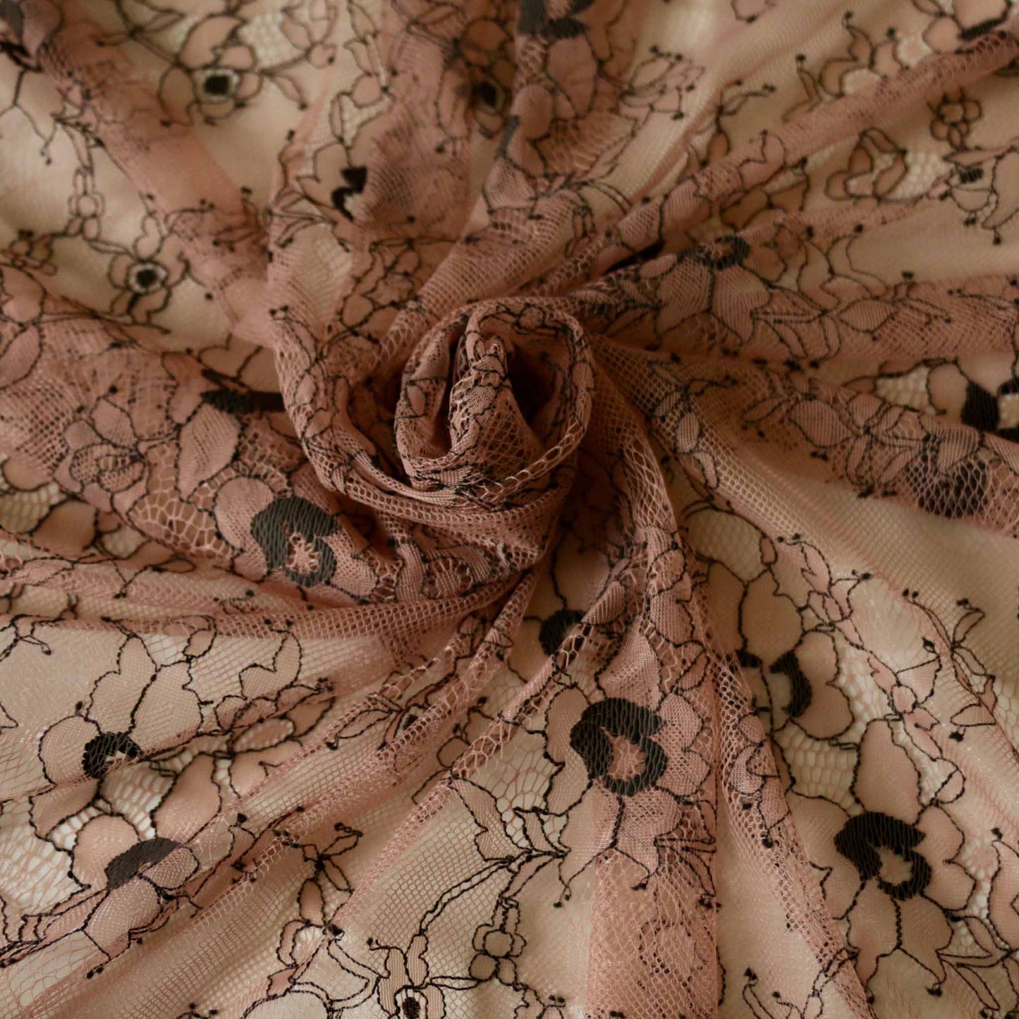 black delicate floral pattern on pink nylon lace fabric for dressmaking