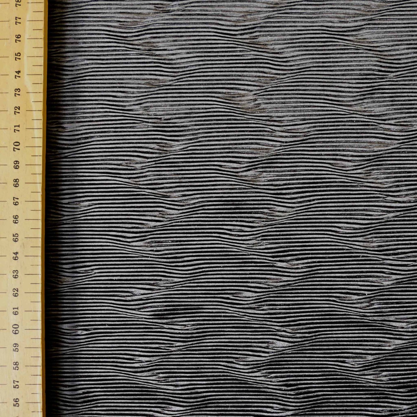 metre black plisse dressmaking fabric with striped pattern