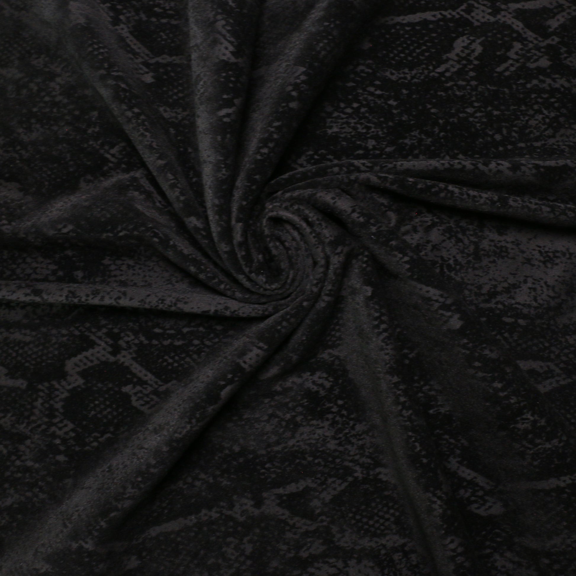 black dressmaking jersey knit fabric with snake skin print
