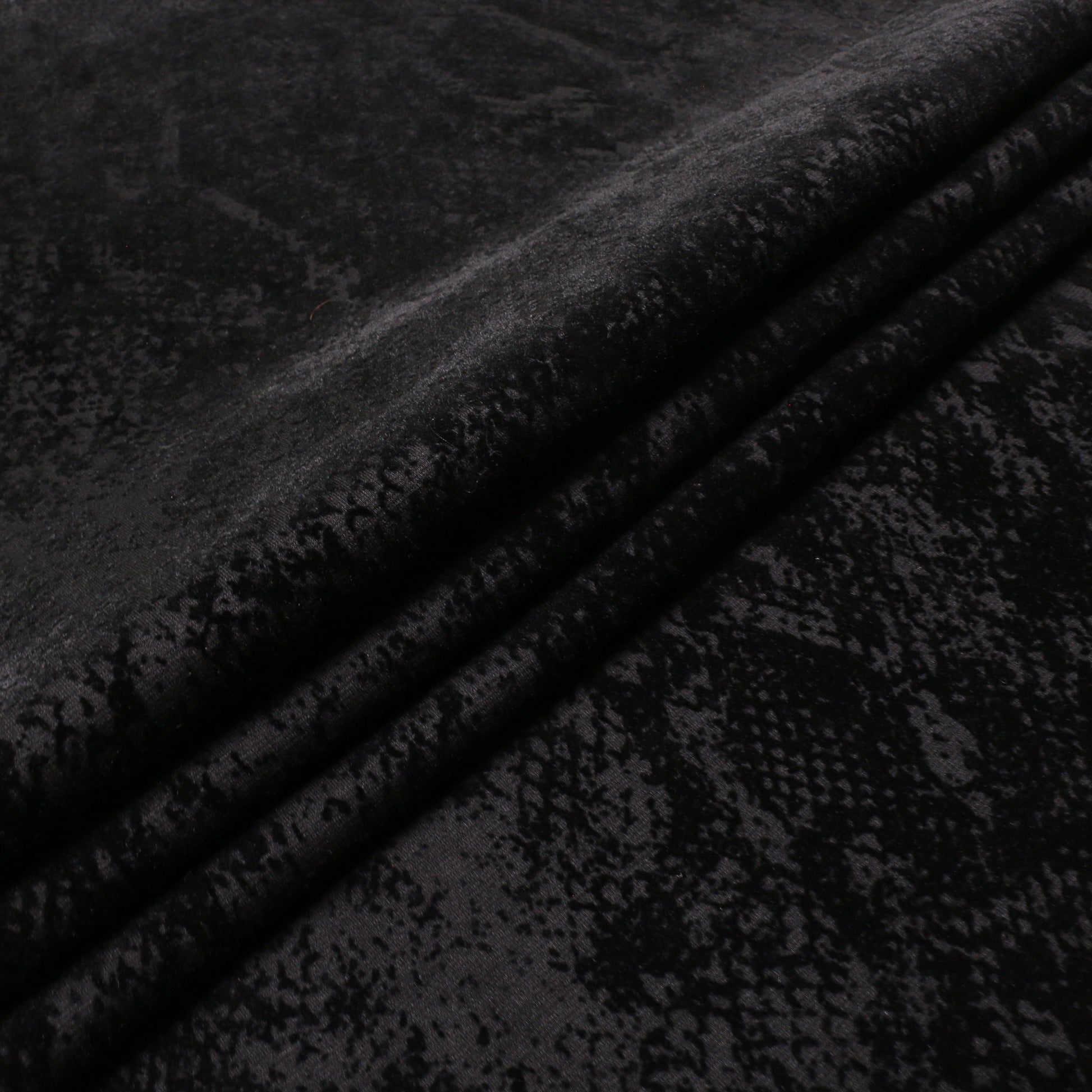 folded ponte Roma dressmaking fabric with black snake skin print