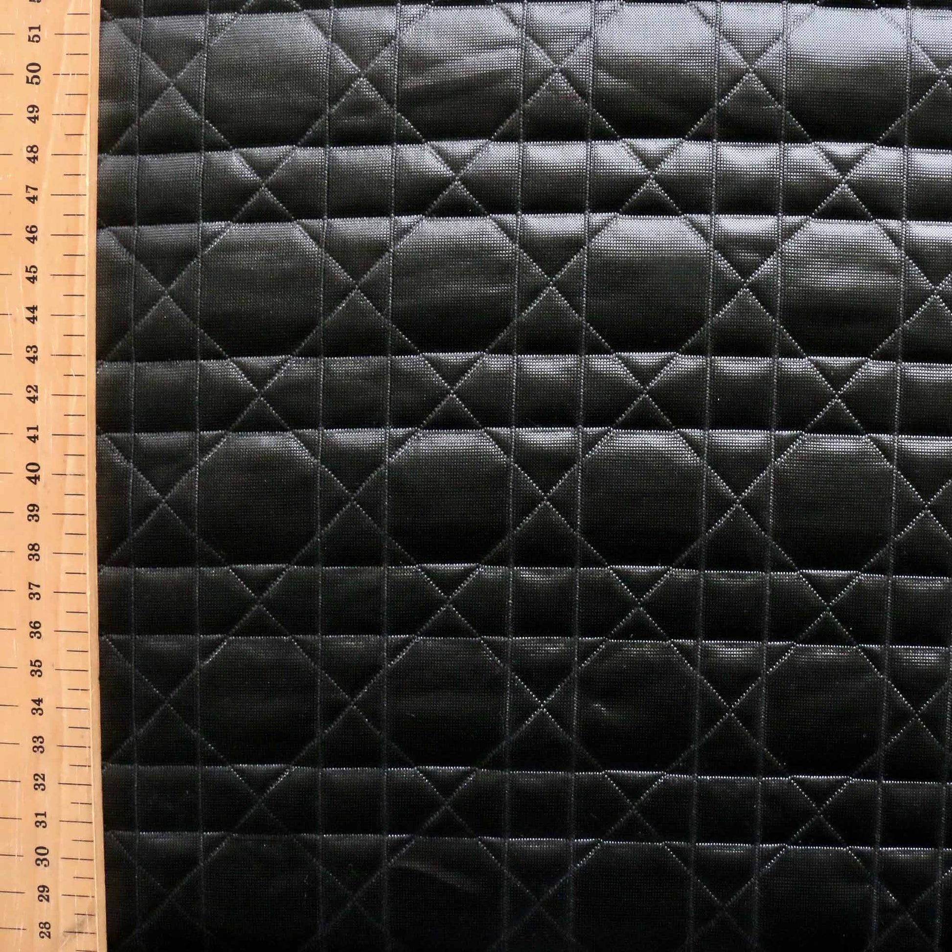 metre black shiny jersey quilting with modern geometric design