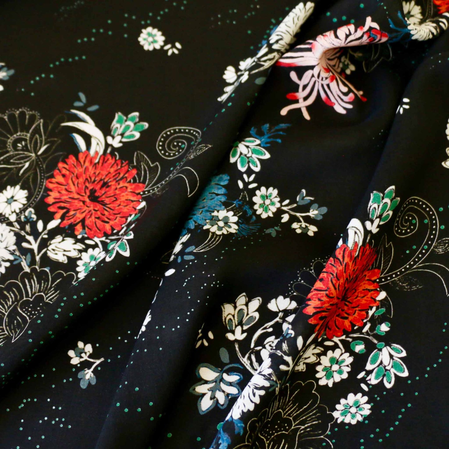 multicoloured floral design on black viscose rayon challis dressmaking fabric