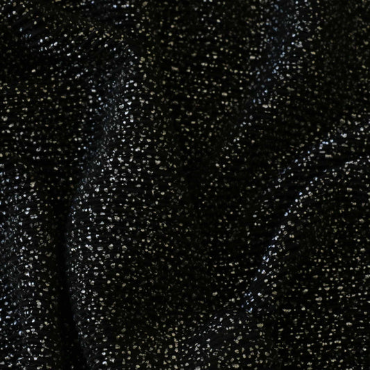 black plisse dressmaking fabric with silver shimmer dot pattern