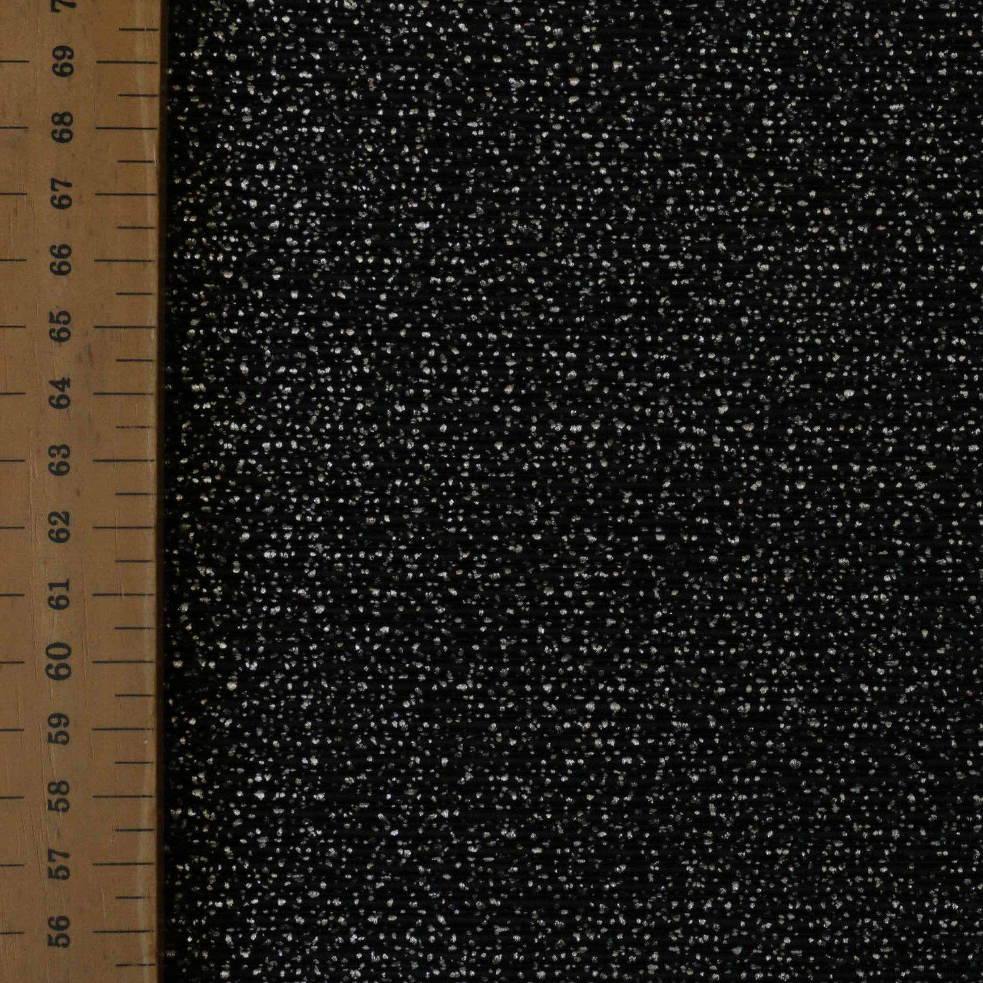 metre black plisse dressmaking fabric with speckled silver shimmer dot pattern