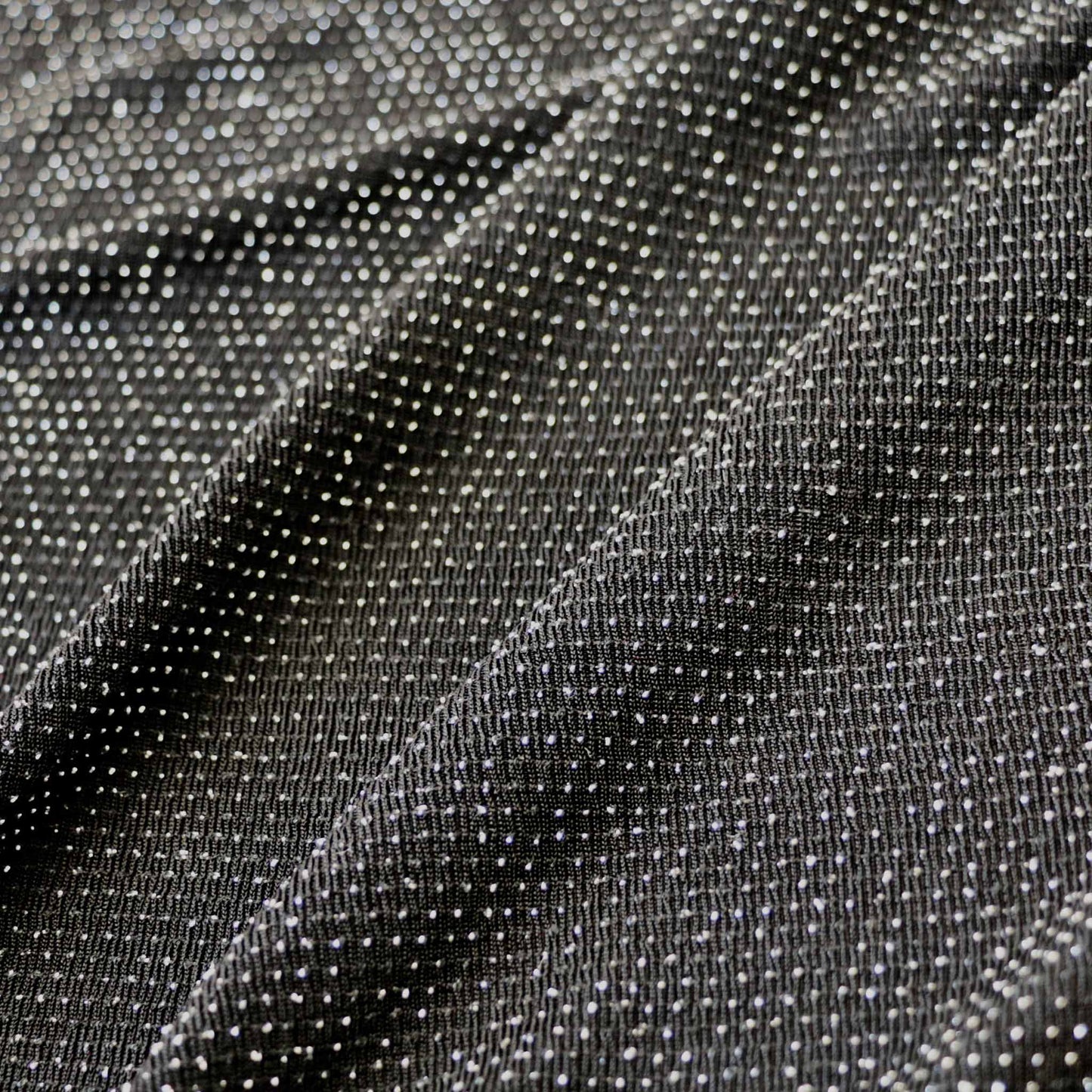 stretchy jersey black dressmaking slinky fabric with silver dot design