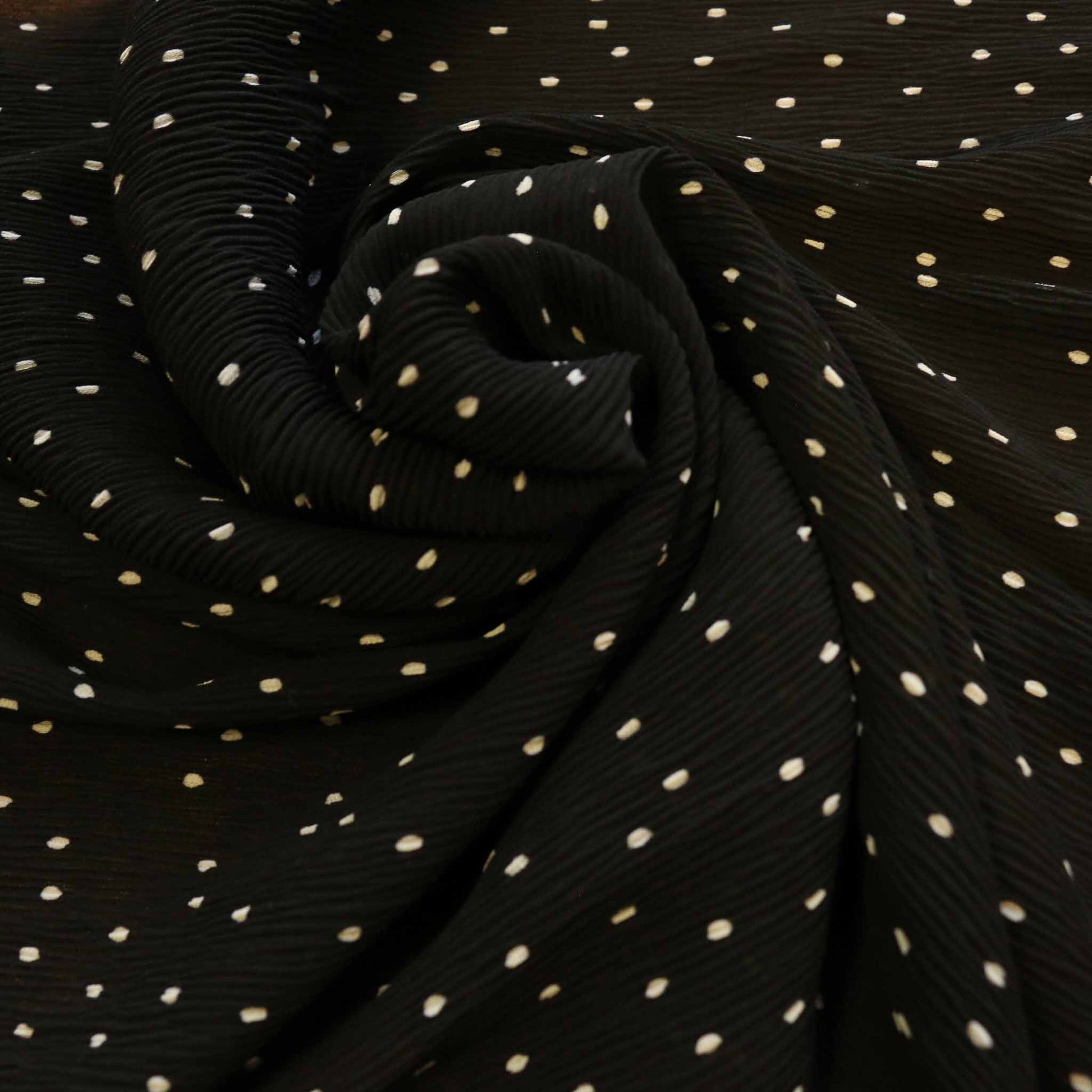 white polka dots on black crinkle georgette dressmaking fabric