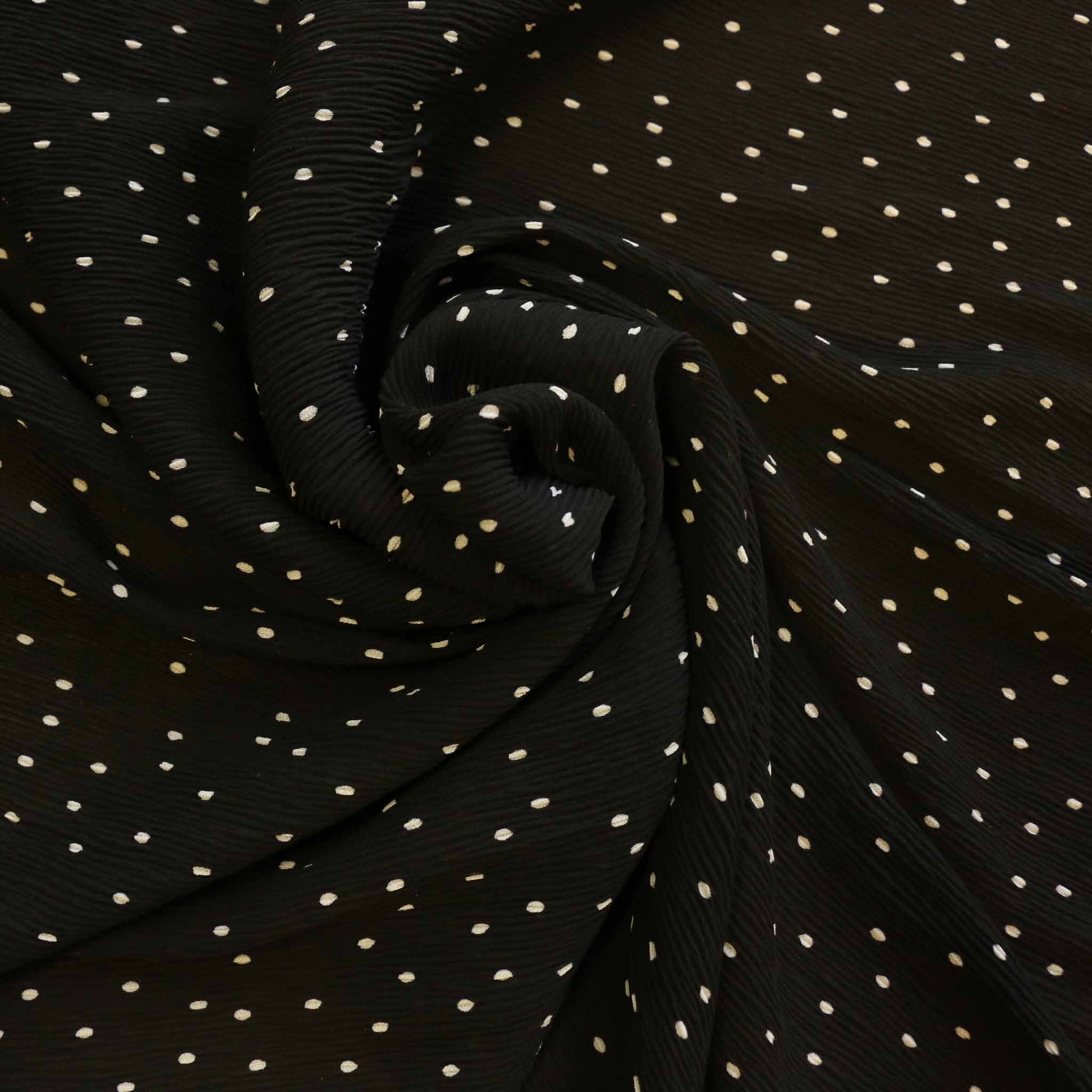 black crinkle georgette dressmaking fabric with white polka dot design