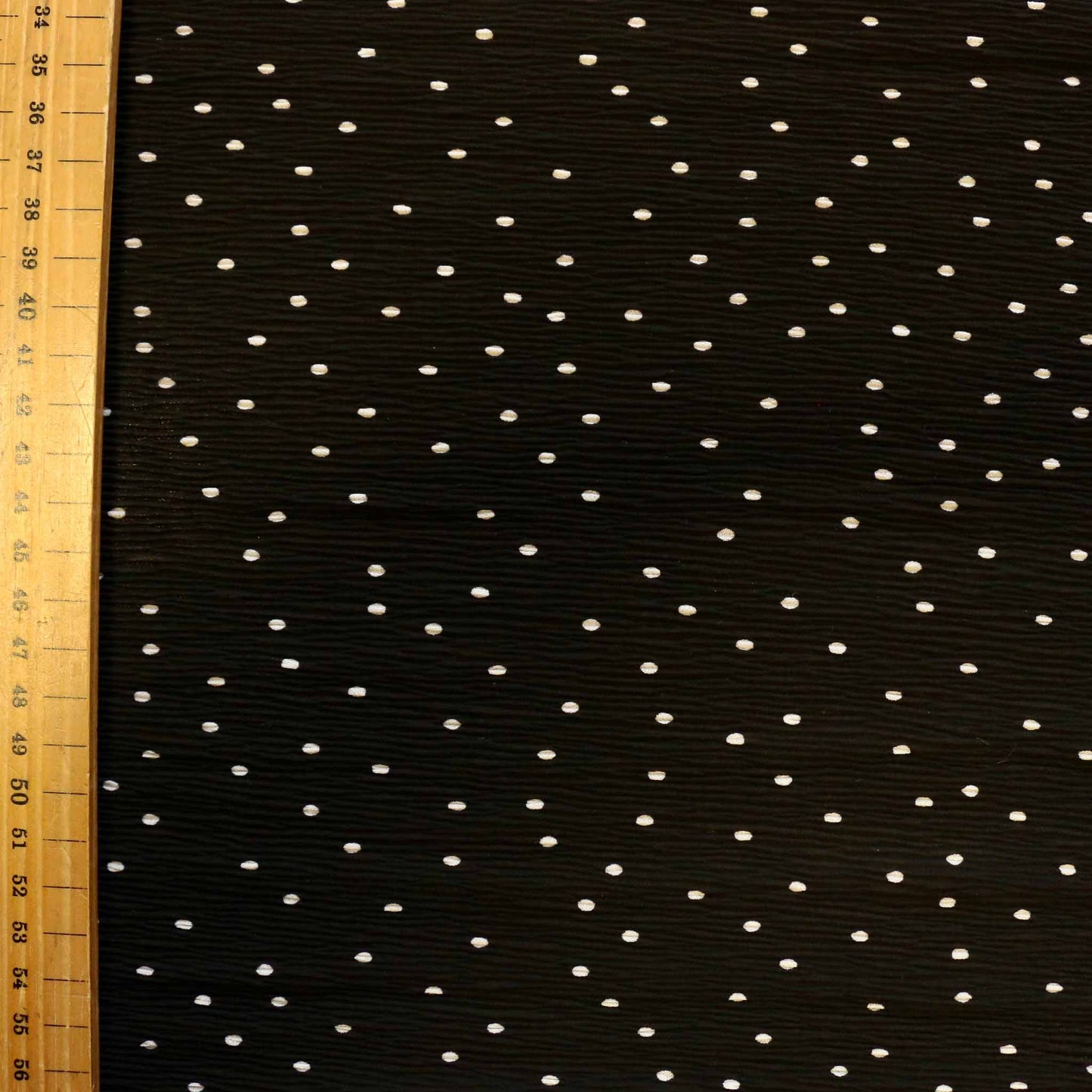 metre dressmaking georgette fabric in black with white polka dots