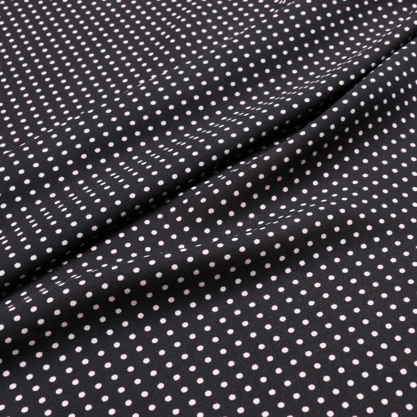 georgette dressmaking fabric with black and white polka dots print