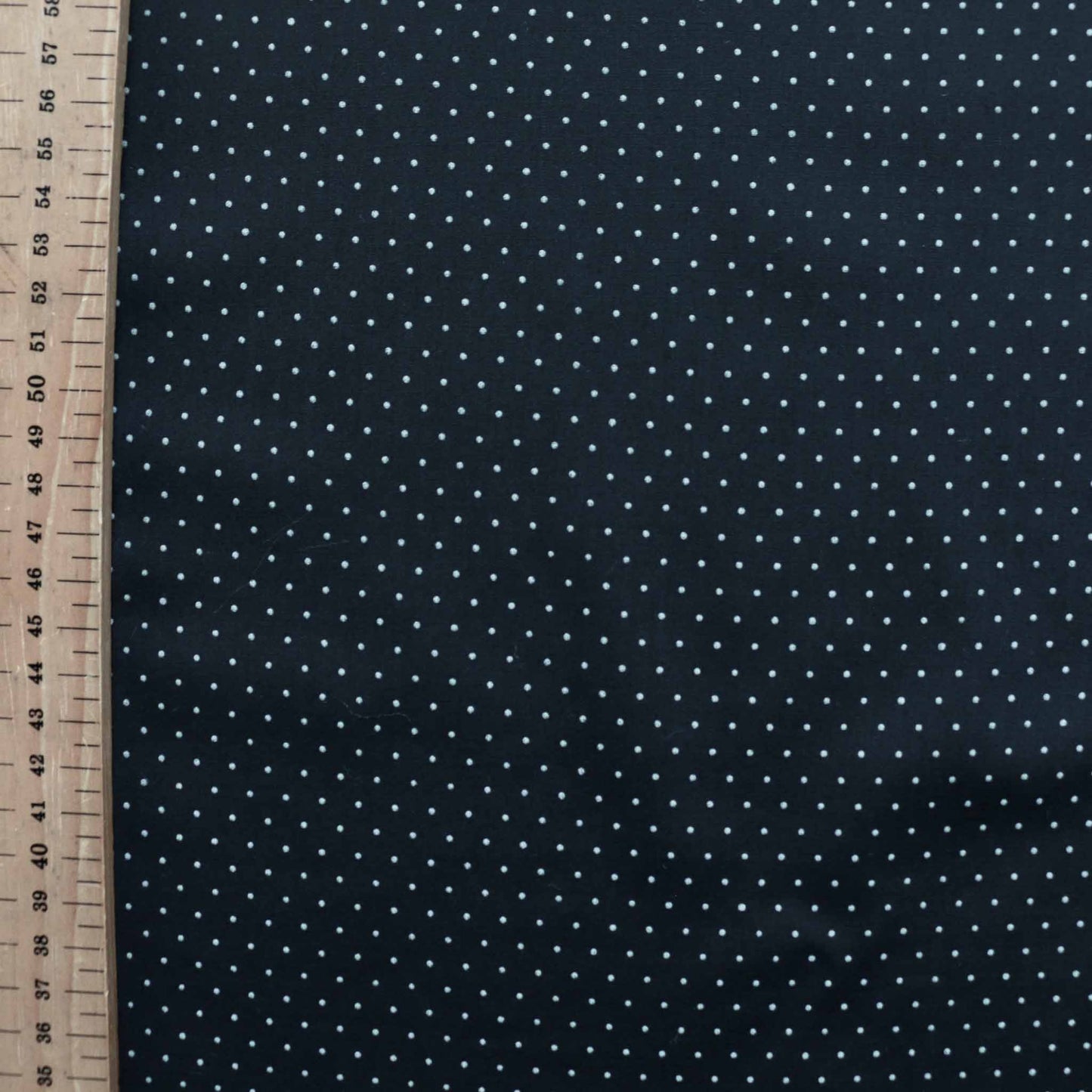 metre white polka dots on black polycotton dressmaking fabric 