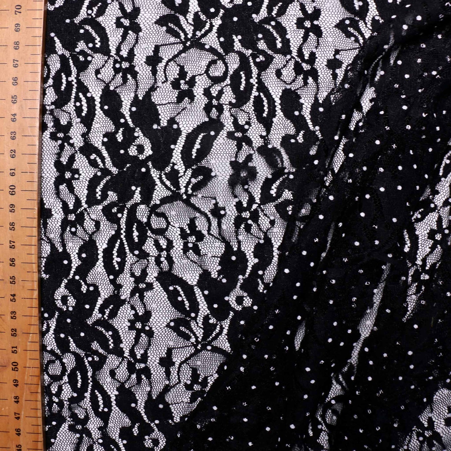 white polka dots on floral stretchy black lace dressmaking fabric