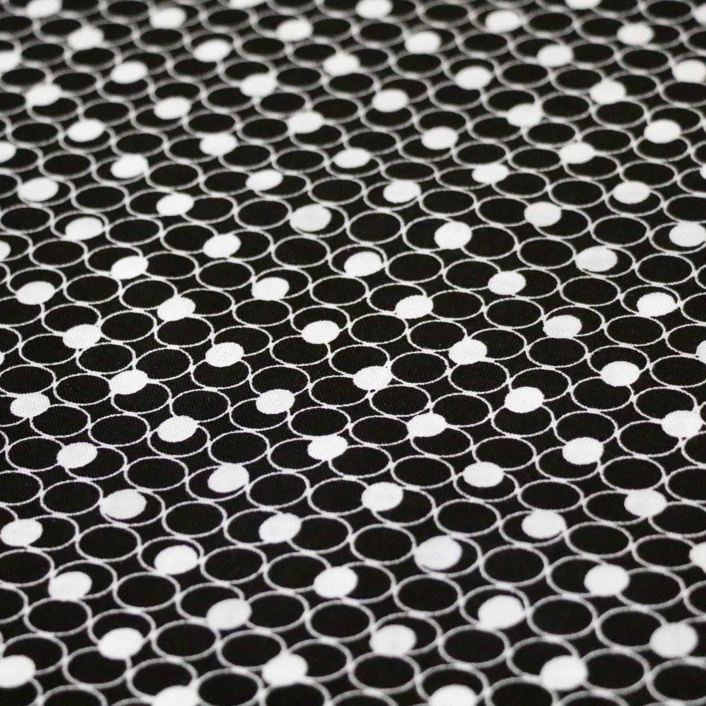 black viscose challis dressmaking rayon fabric with white circle print
