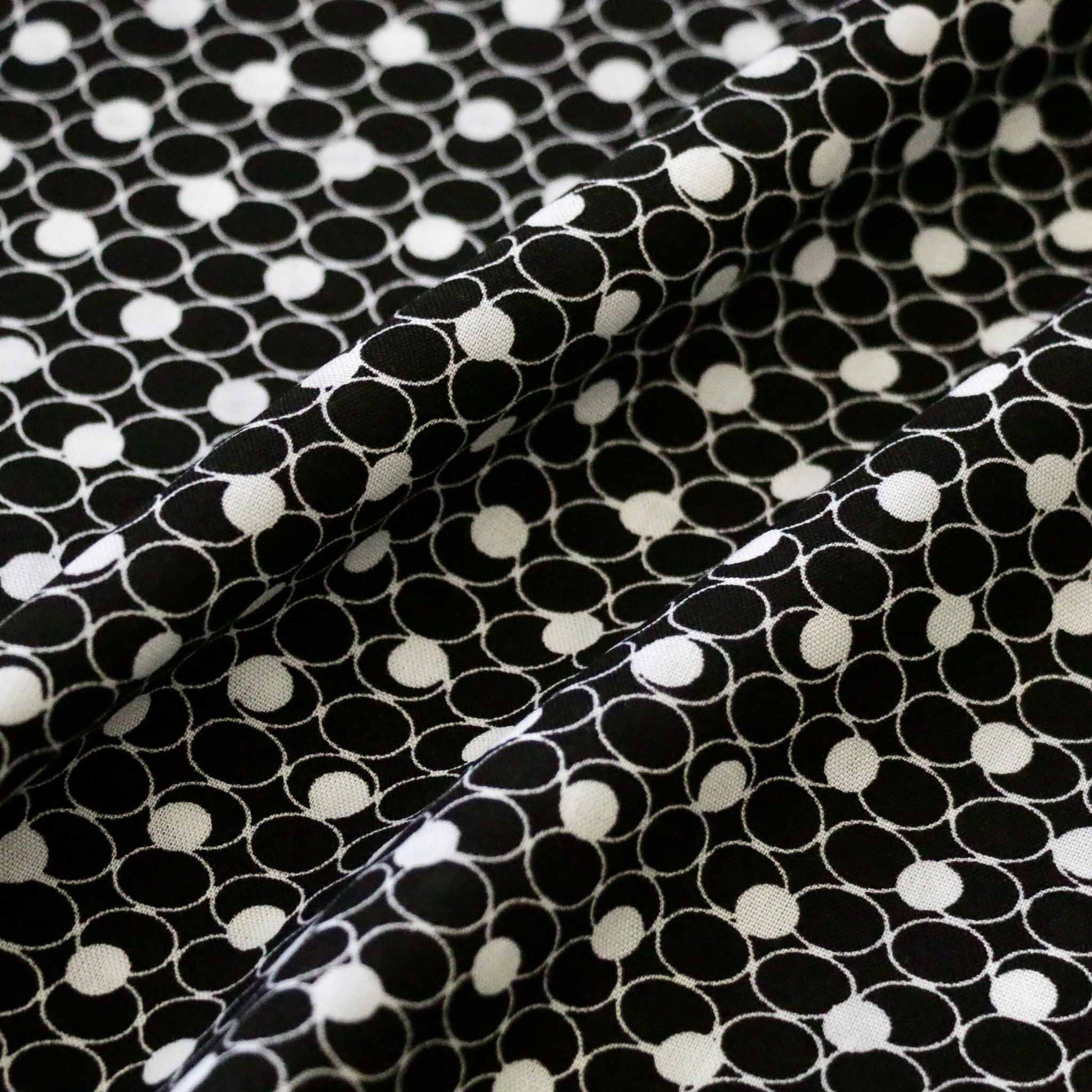 black and white viscose challis dressmaking fabric with geometric circle design