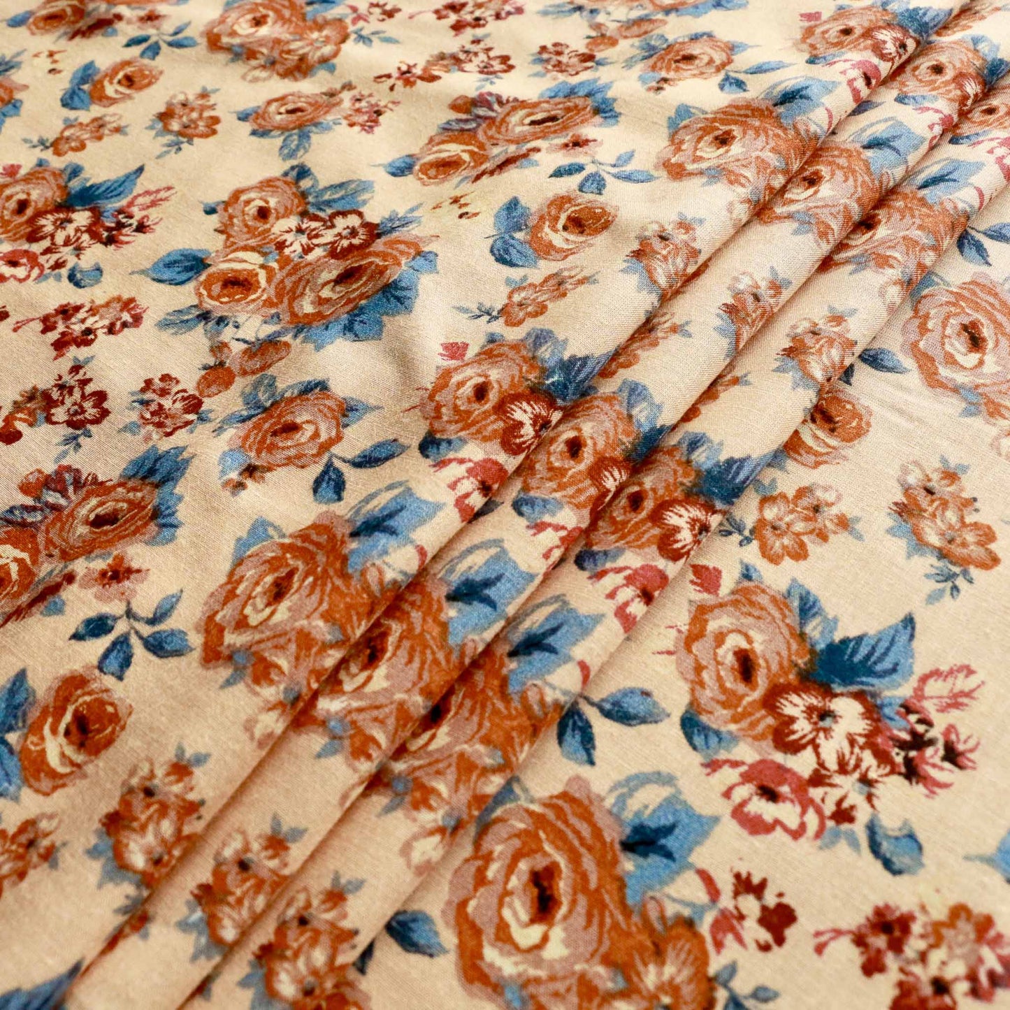 light beige viscose challis dressmaking fabric with brown and blue floral print