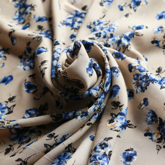 beige viscose challis dressmaking rayon fabric with delicate blue floral print