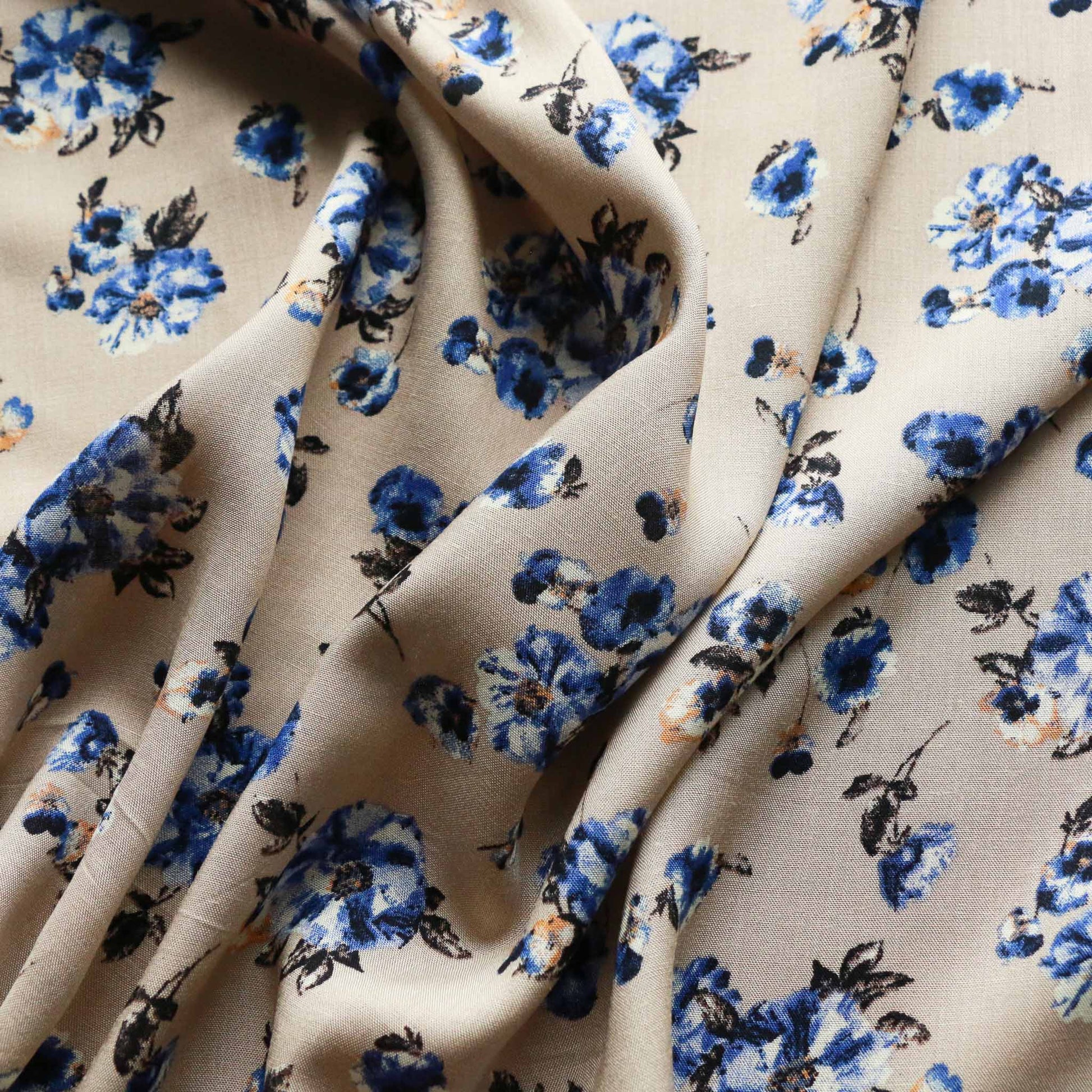 blue flowers printed on earthy beige coloued viscose challis dressmaking rayon fabric