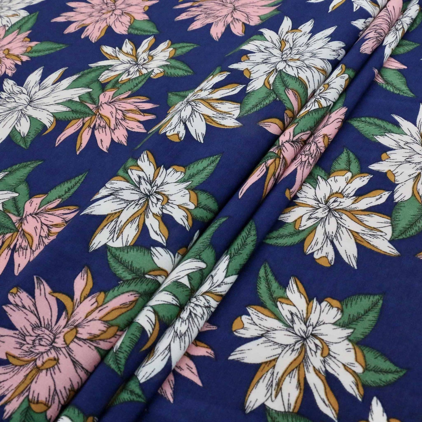 folded blue chiffon dressmaking polyester synthetic fabric with printed flower design