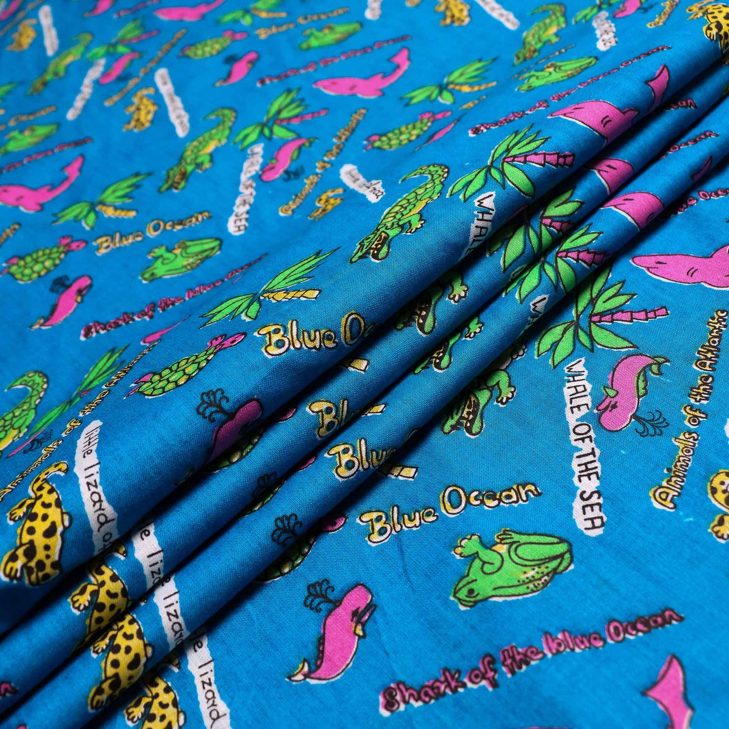 blue retro cotton dressmaking sustainable deadstock fabric with pink green sea animals print