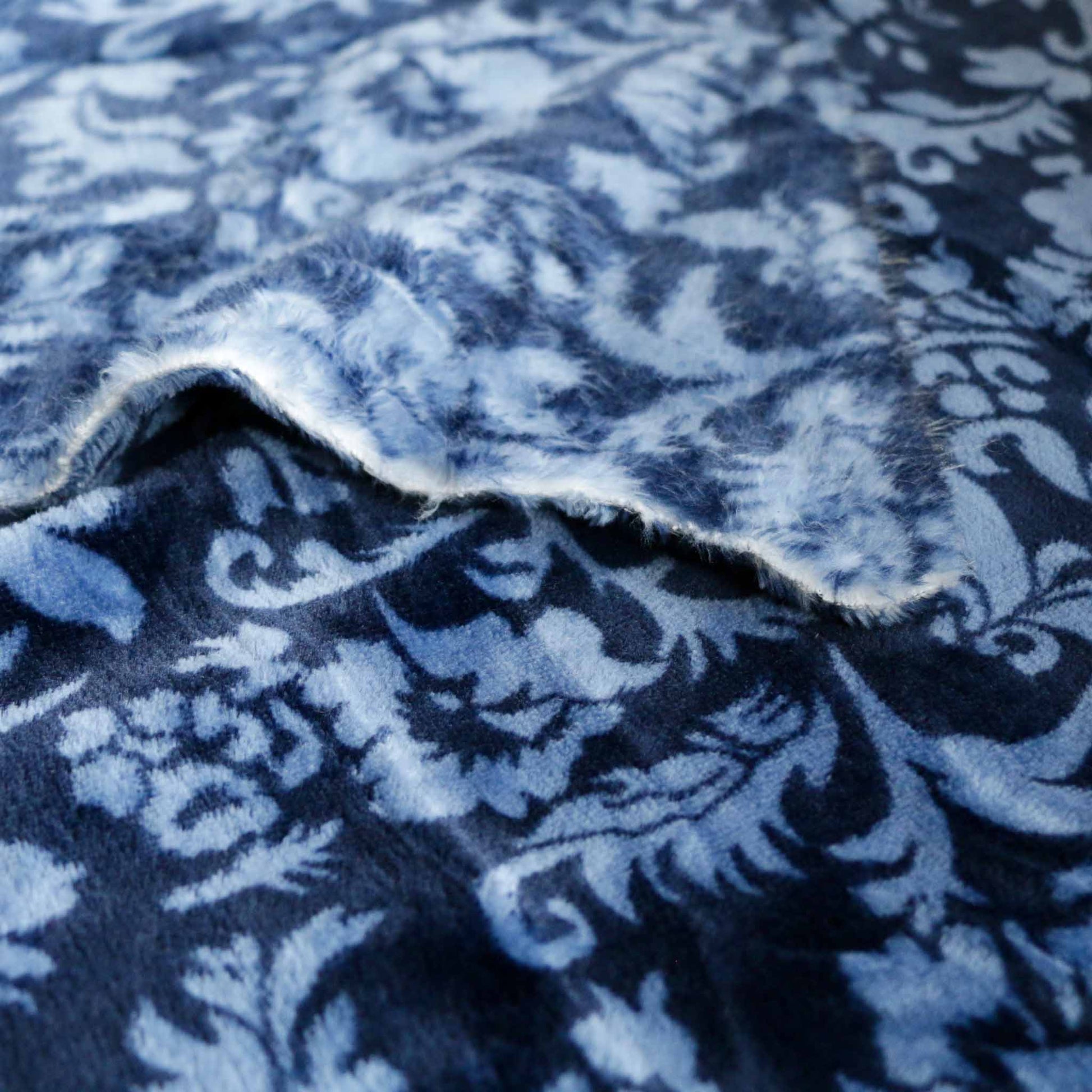 soft blue fleece dressmaking fabric with classical design print