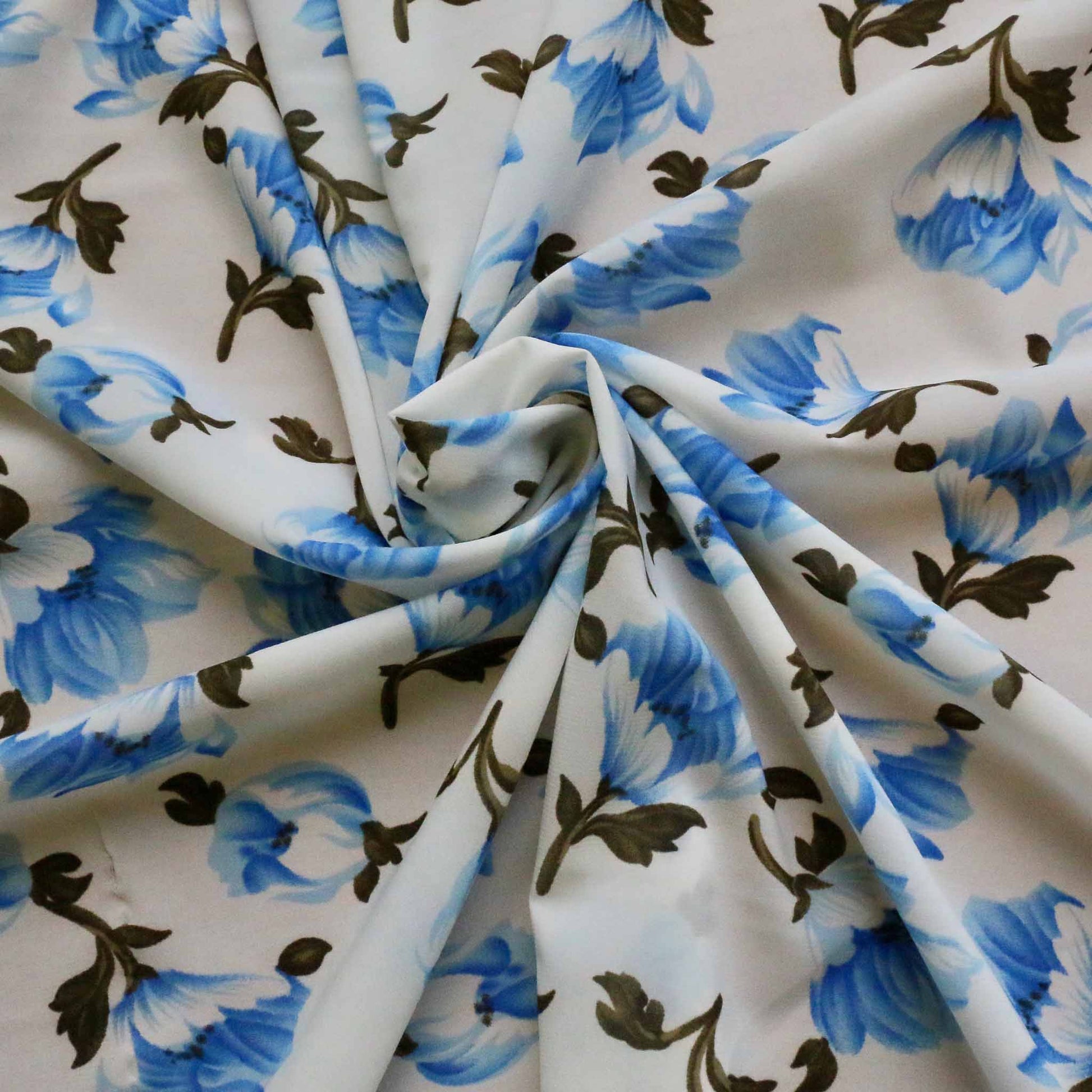 white chiffon polyester stretchy synthetic dressmaking fabric with blue floral print