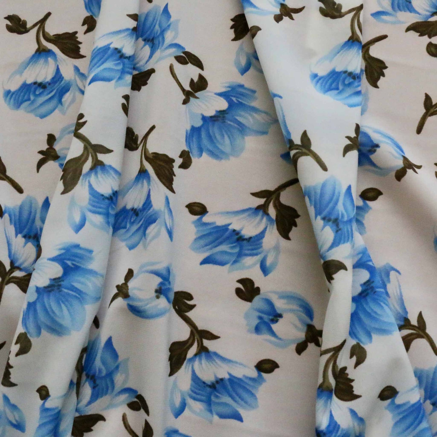 blue flower printed on white chiffon polyester synthetic stretchy dressmaking fabric