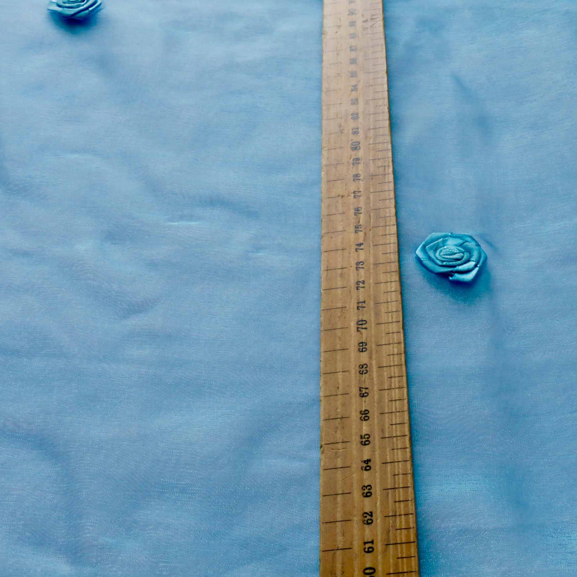 metre blue organza dressmaking fabric with rose embellishment