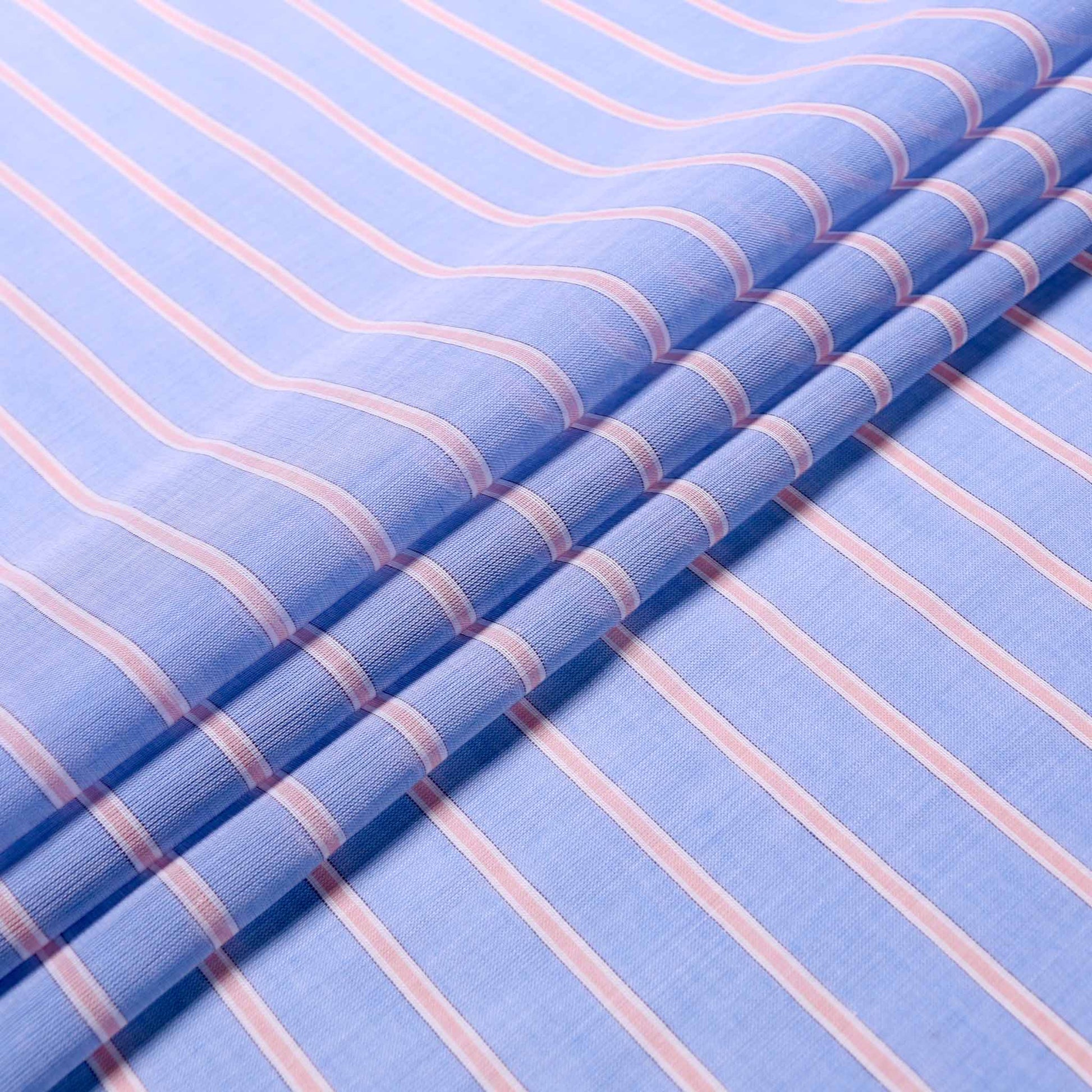 folded cotton voile dressmaking fabric in blue with pink stripes