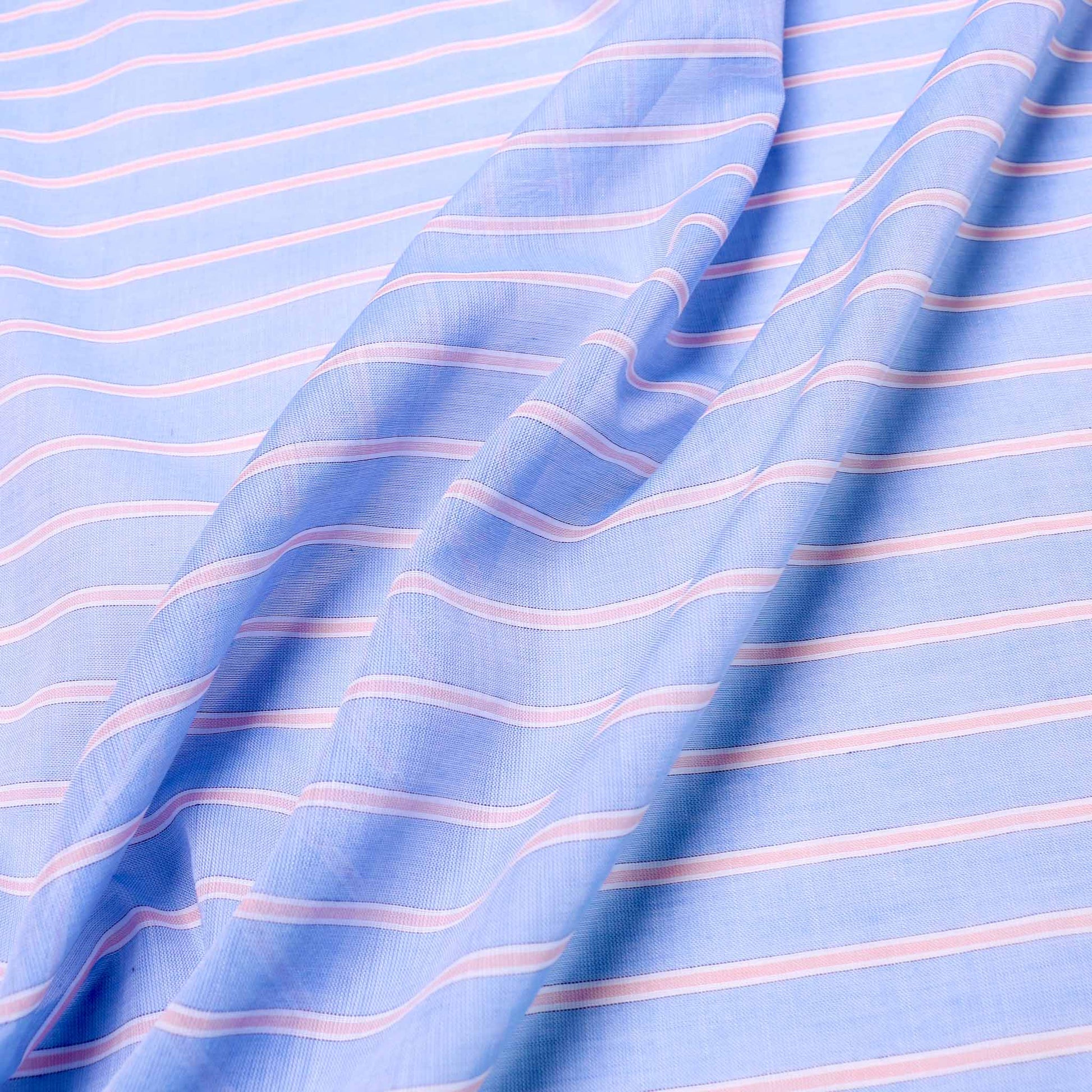 pink stripes on pale blue cotton lawn dressmaking fabric by clothcontrol