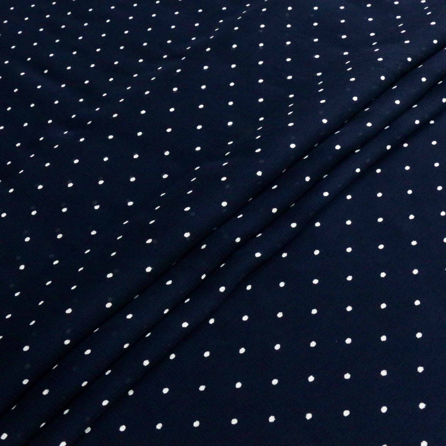white polka dots on blue viscose chiffon dressmaking fabric